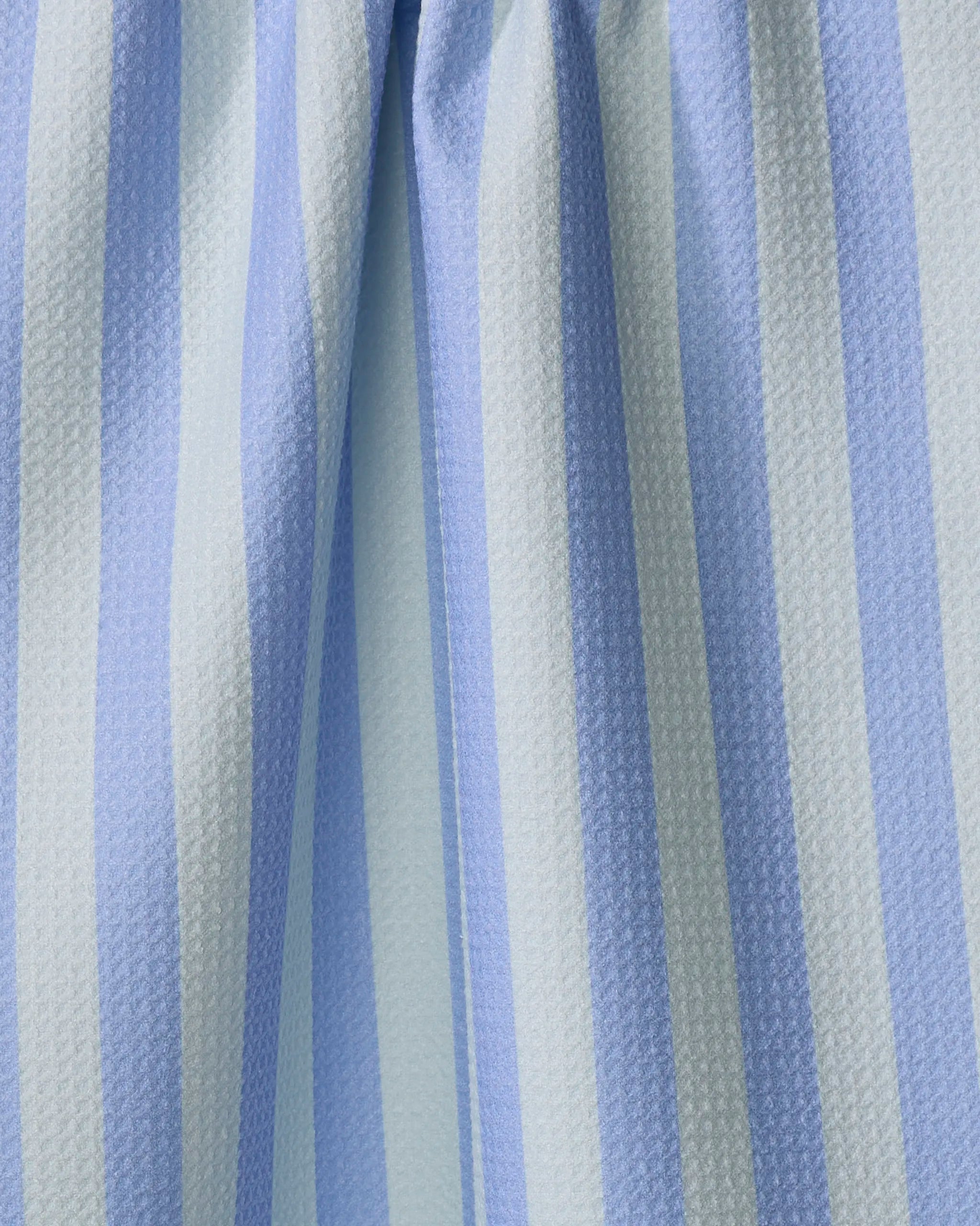 Cabana Boy - French Blue Mint by The Buy Guide features light blue and white vertical stripes on textured recycled fabric—perfect for an ultra-absorbent tea towel with soft folds and gentle shadows.