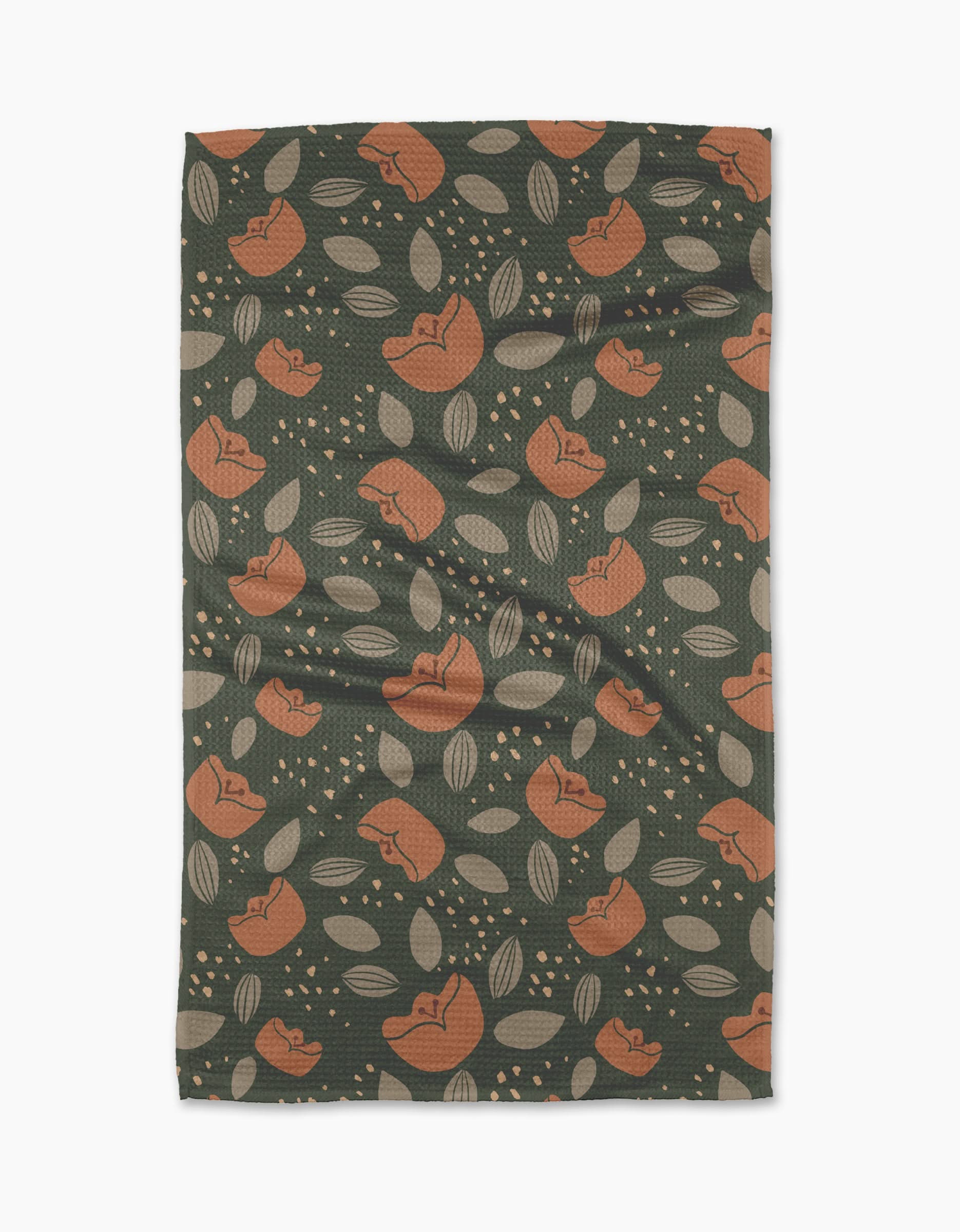 Cali Sun by Amberleigh Adoff features a dark green background with orange flowers, beige leaves, and dots. This ultra-absorbent, slightly textured towel is stylish and functional—perfect for any kitchen.