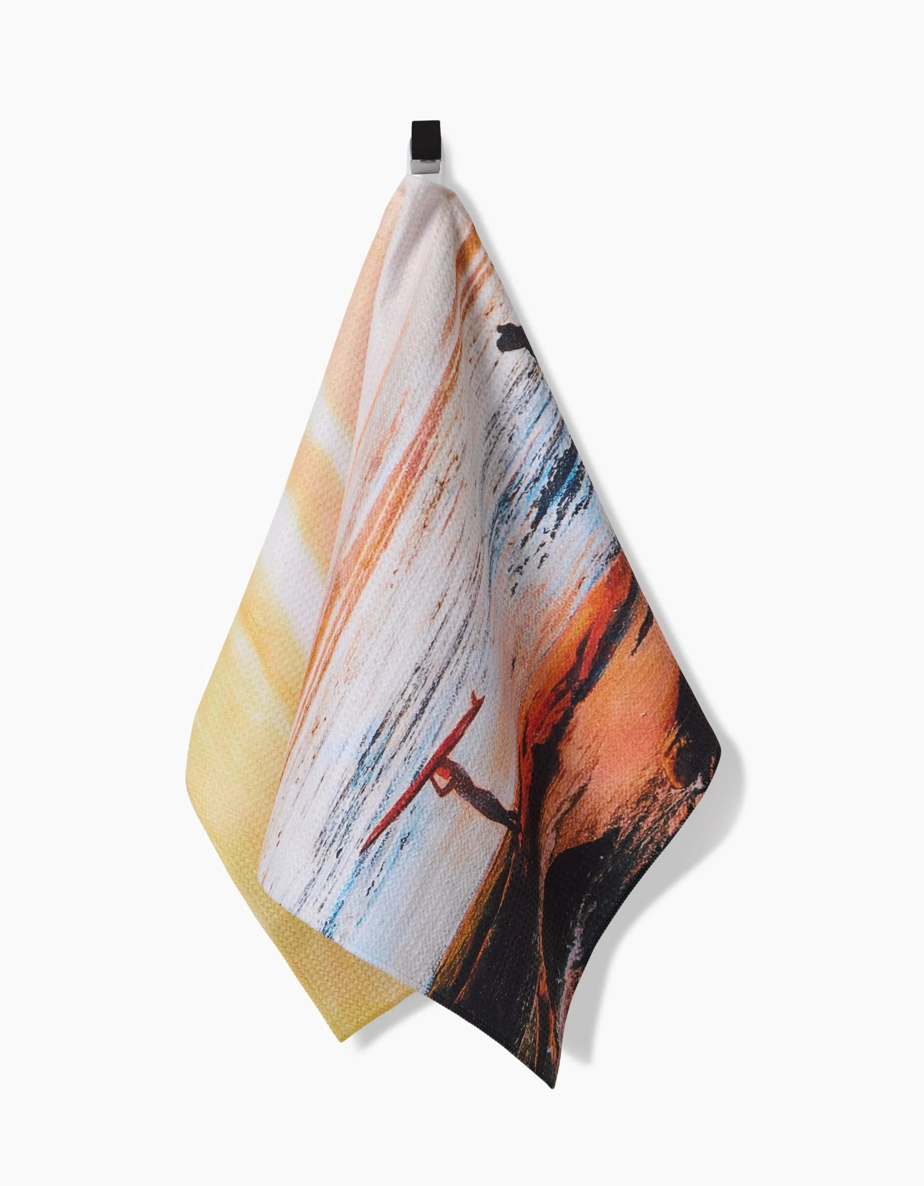 The Call Of The Wild Tea Towel by Stefanie Bales features a sunset surfing scene on Geoweave fabric and hangs from a black loop against a white background.
