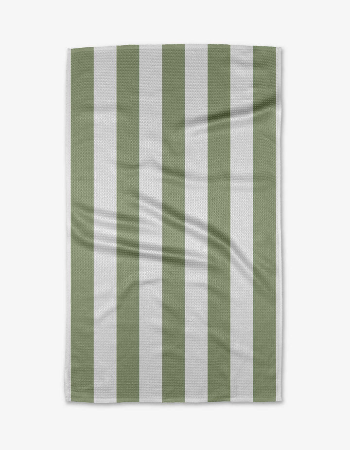 The Candy Mint tea towel by Kailee Wright is rectangular with vertical sage green and white stripes. Displayed flat, its quick-drying fabric shows a subtle textured pattern and slight creases against a white background.