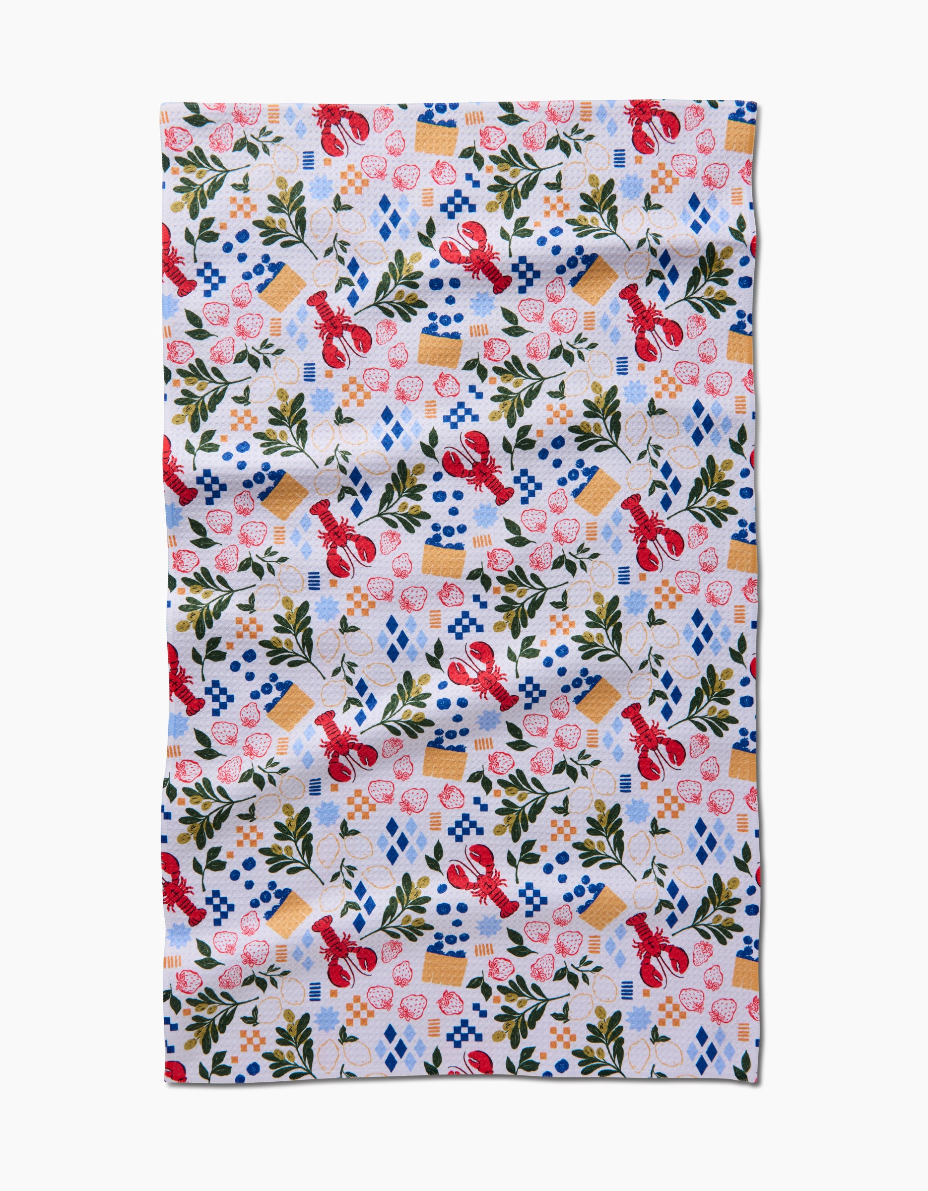 Capri by Charlie Rowan Designs is a patterned tea towel made from Geoweave Fabric, featuring red lobsters, blueberries, strawberries, lemon slices, leafy branches, blue checkered napkins, and white plates on a textured background.