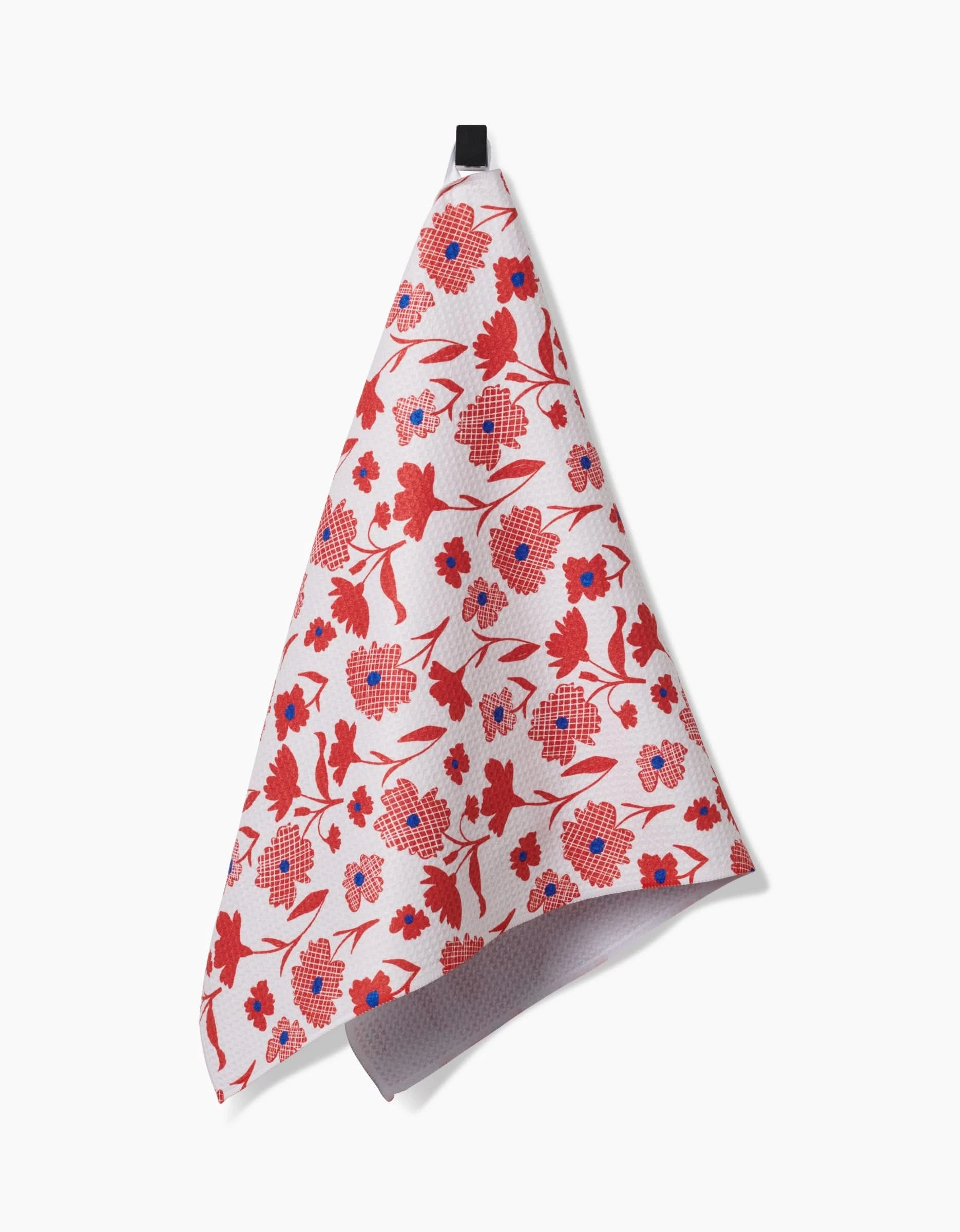 The Carmine tea towel by Danelys Sidron, crafted from soft Geoweave fabric, features a red and blue floral pattern and hangs from a black loop against a plain white background.