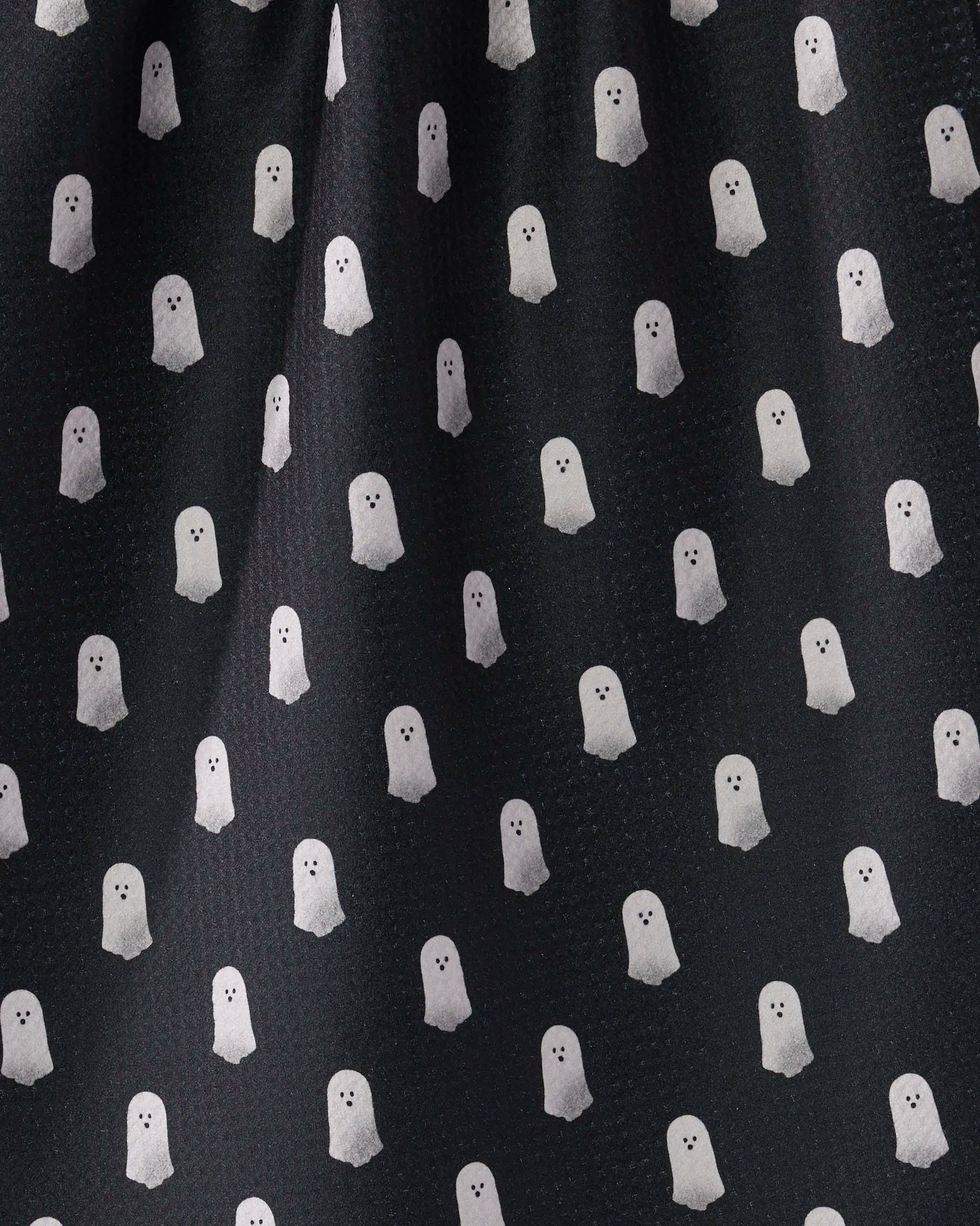 Casper Boo by Geometry is a black kitchen tea towel featuring a repeating pattern of small white ghosts, each with eyes and an open mouth, crafted from recycled materials—perfect for adding charm to your home.