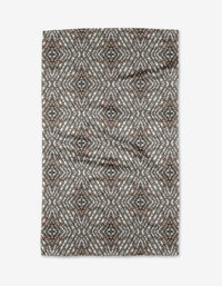 The Katherine Berkeley Cha Cha Interchange tea towel features a geometric diamond pattern in gray, white, black, and rust tones, creating a symmetrical kaleidoscope-like design on this quick-drying rectangular towel.