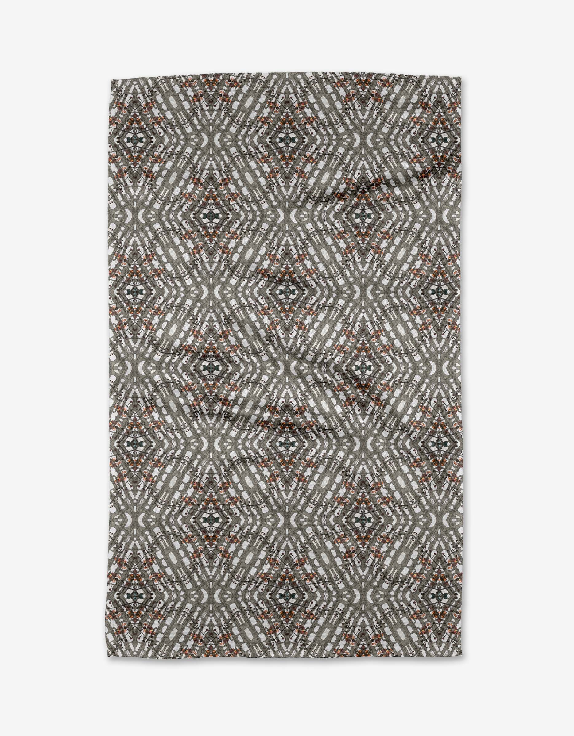 The Katherine Berkeley Cha Cha Interchange tea towel features a geometric diamond pattern in gray, white, black, and rust tones, creating a symmetrical kaleidoscope-like design on this quick-drying rectangular towel.