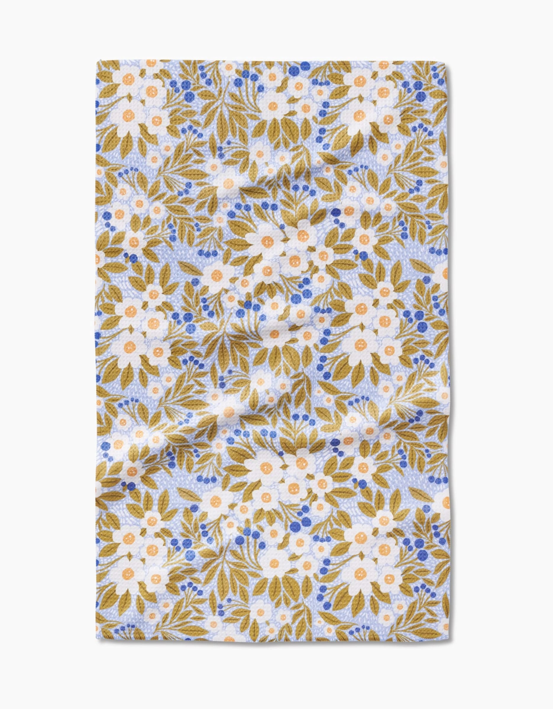 The Chamomile And Blue tea towel by Lisa Nelson features white and yellow flowers, green leaves, and blue accents on ultra-absorbent Geoweave™ fabric, neatly folded against a white background.