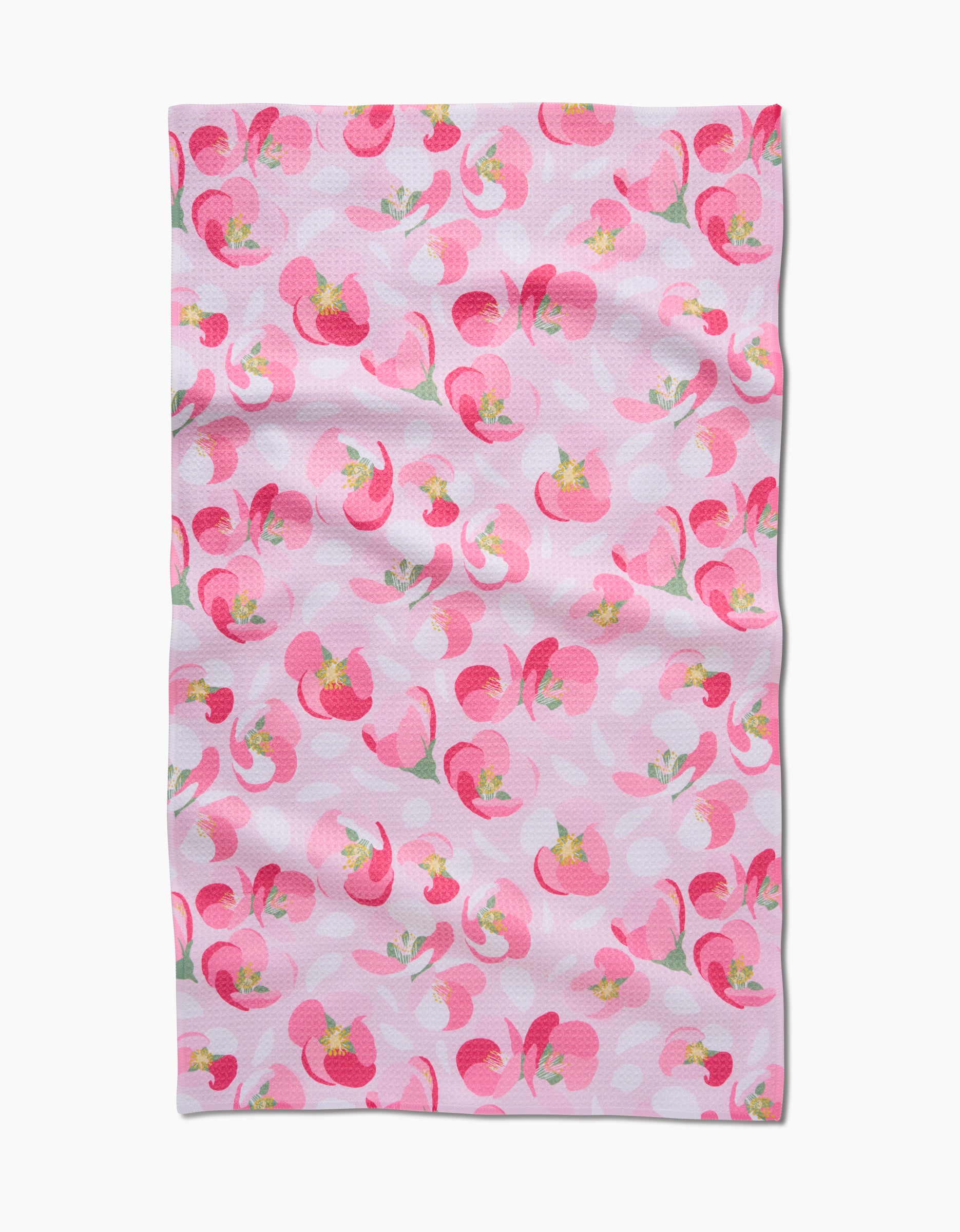 The Cherry Blossom by Rebecca Bobko is a cloth towel made from ultra-absorbent Geoweave fabric, with a pink background and abstract pink and red florals accented with green and yellow. Slight fabric wrinkles are visible.