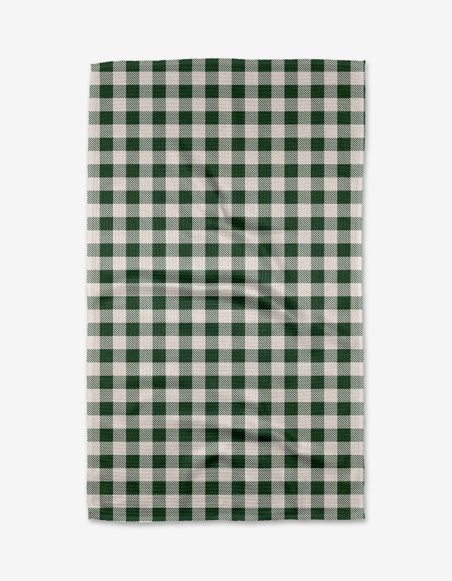 The Aubrey Fairchild Christmas Gingham tea towel features a green and white checkered pattern with evenly spaced squares. The rectangular fabric shows slight wrinkles and is displayed on a plain white background.