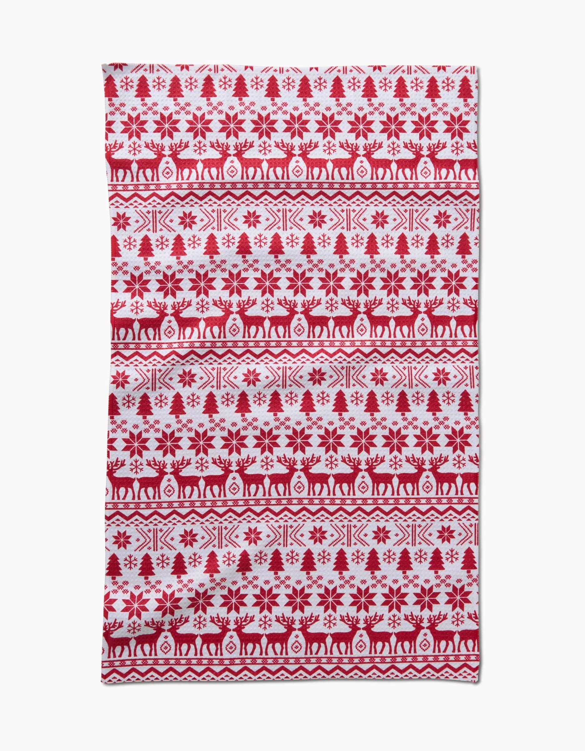 The Hufton Studio Christmas Jumper features red and white Scandinavian-style patterns with rows of stylized trees, snowflakes, and reindeer in horizontal bands.