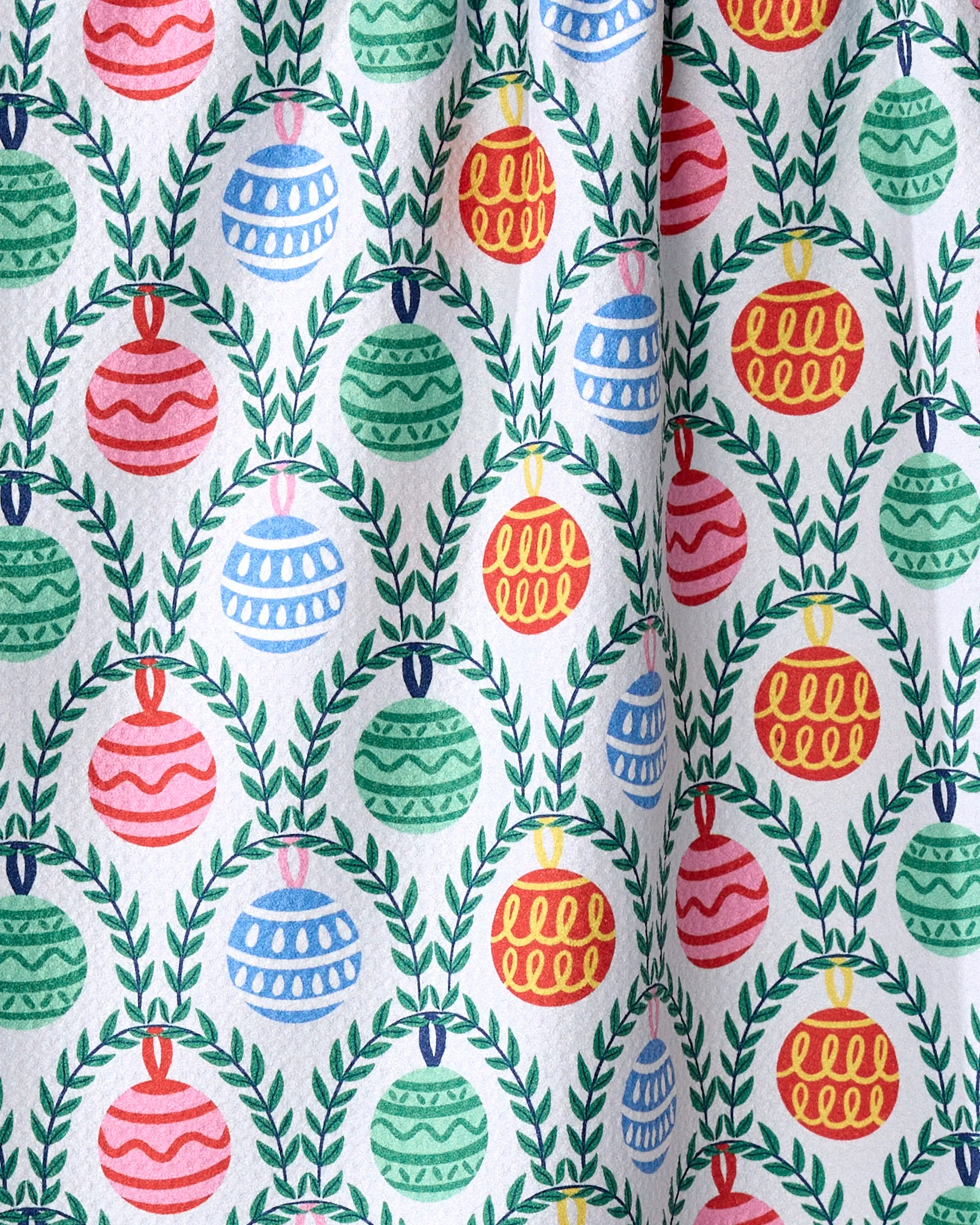 The Ceyda Alasar Christmas Ornaments recycled kitchen towel features rows of red, green, and blue ornaments with decorative patterns, framed by green leafy wreaths for a festive holiday look.