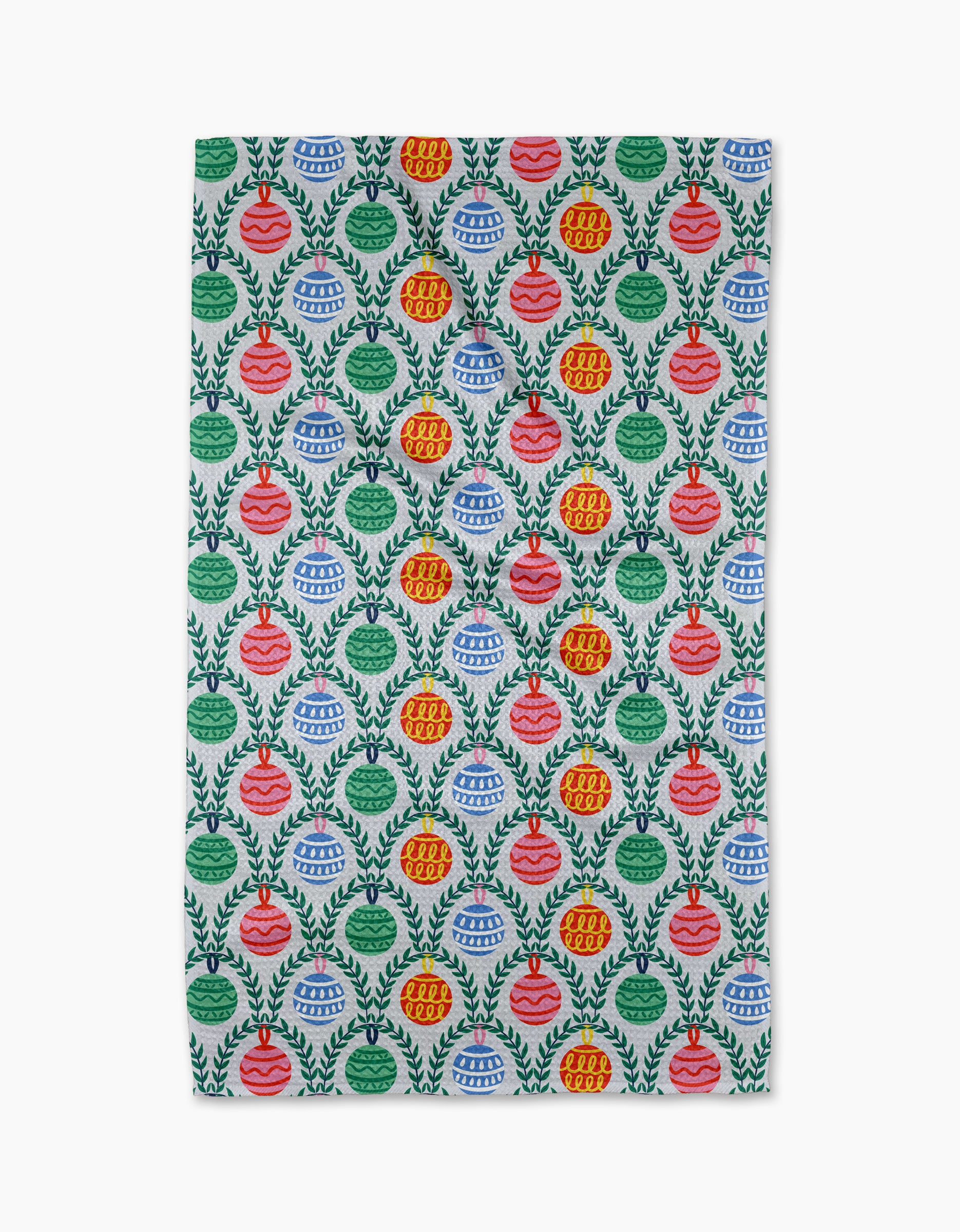 The Ceyda Alasar "Christmas Ornaments" tea towel features red, green, and blue ornament patterns with leafy wreaths on white, made from recycled materials for an eco-friendly, ultra-absorbent kitchen accessory.