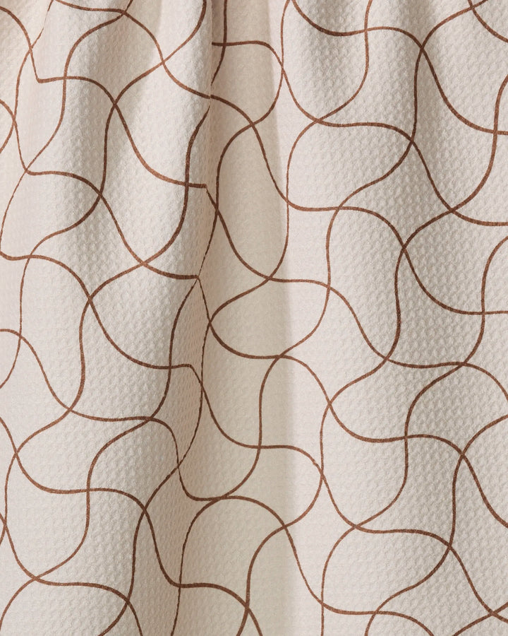 Clarity by Gerdadzy is a beige, textured tea towel made from recycled materials, featuring thin wavy brown lines in abstract shapes—ultra-absorbent and stylish for any kitchen.