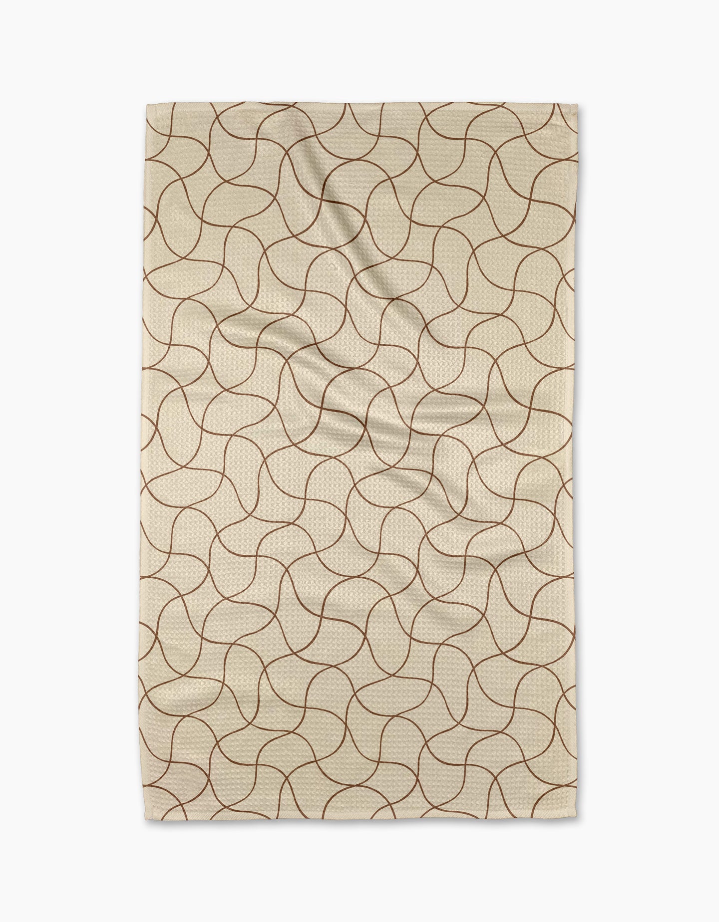 The Gerdadzy Clarity kitchen towel, beige and rectangular with a wavy intersecting brown pattern, made from recycled materials, is shown laid flat with gentle folds on a white background.