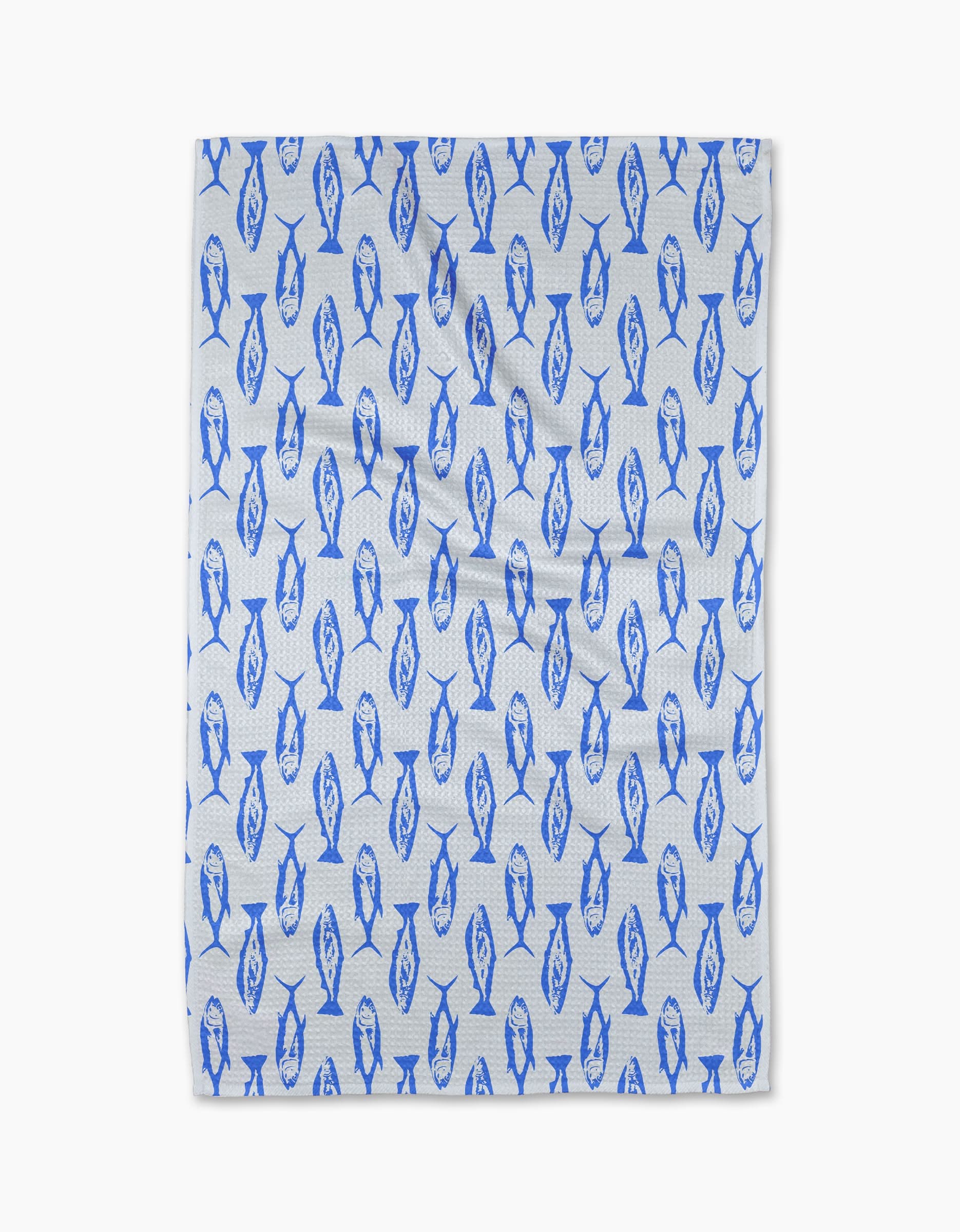 The Geometry Coastal Catch Tea Towel, made from Geoweave fabric, features a repeating blue fish pattern and is shown flat against a plain white background.