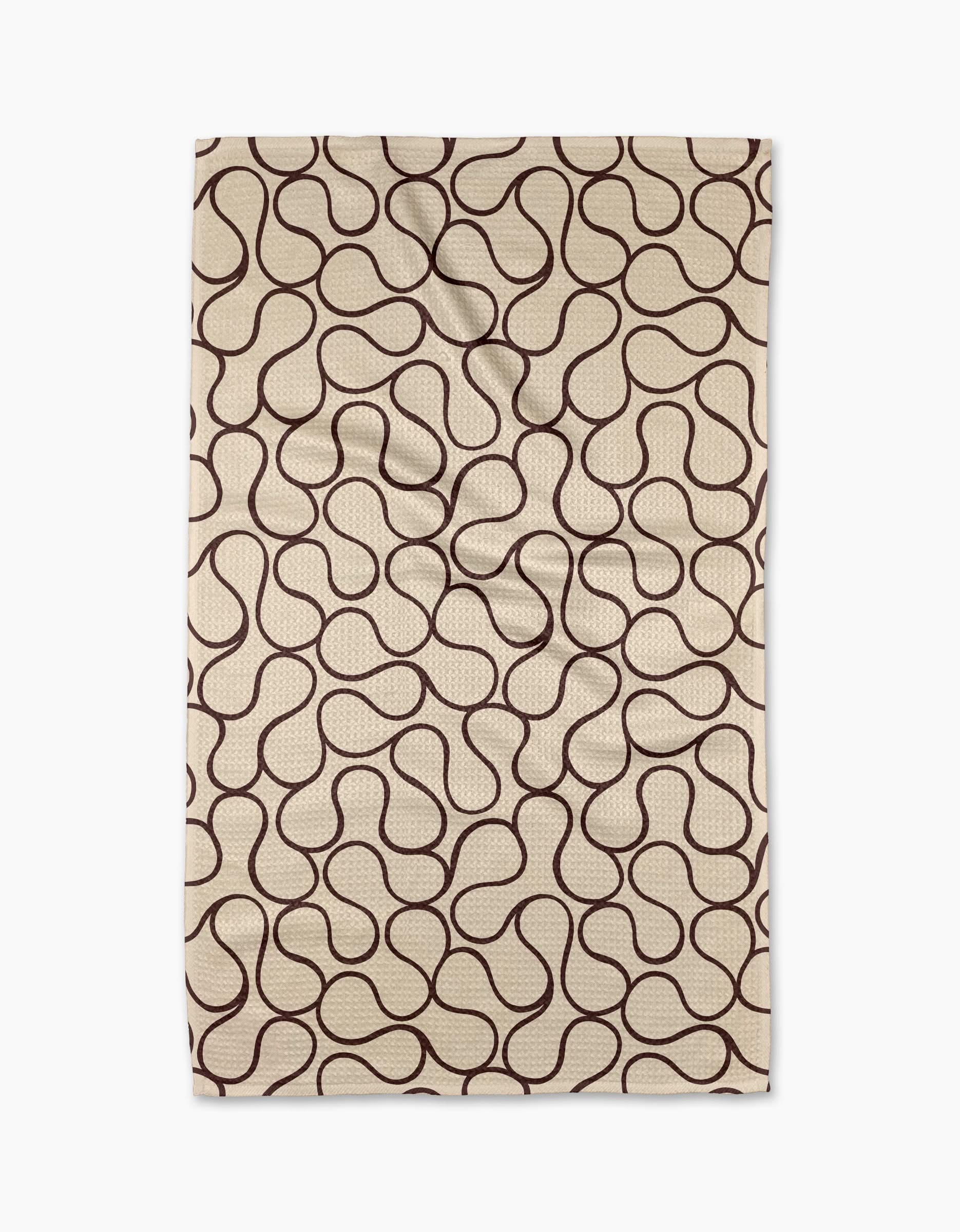 The Gerdadzy Coffee Swirl rug is a beige rectangular piece made from recycled materials, featuring an abstract wavy brown line pattern across its surface.