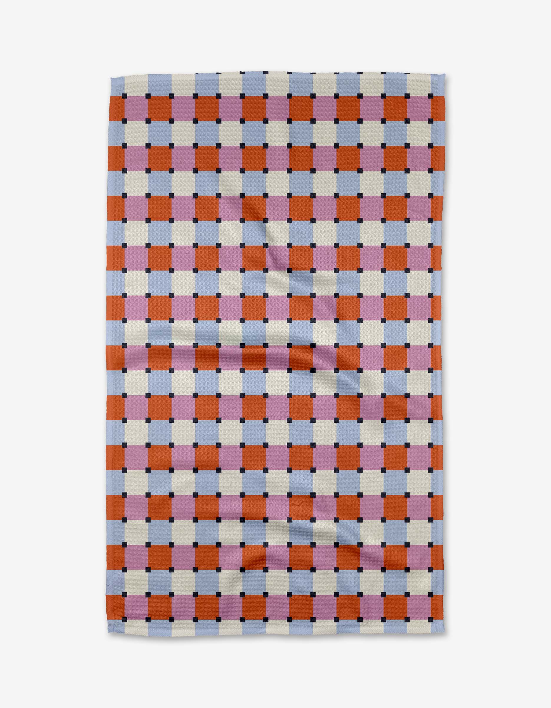 The Color Block Grid Tea Towel by Claire Iglesias features a checkered pattern with orange, blue, purple, and white squares. Made from Geoweave fabric, it has a slightly textured surface with visible creases.