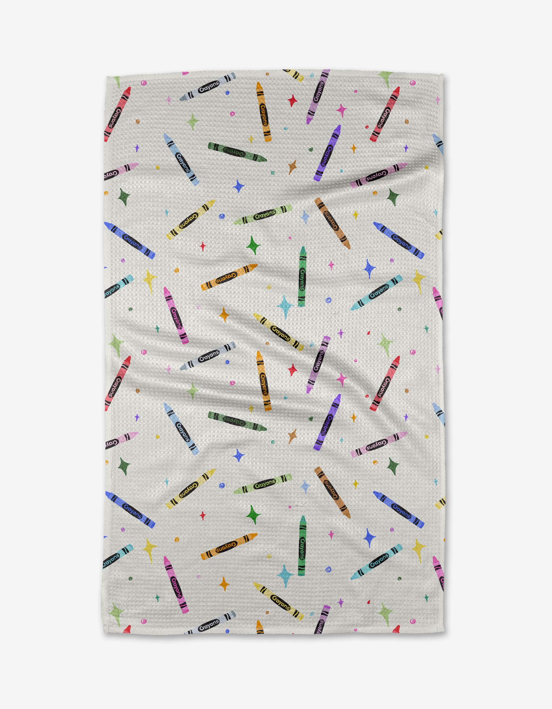 The Vaishali Design Studio Colored Crayons tea towel features a colorful crayon and multicolored star pattern on white, made from quick-drying recycled materials with a slightly wrinkled texture for charm.