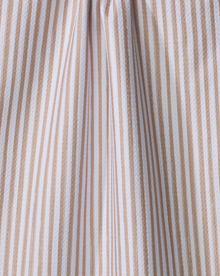 Close-up of the "Cookie" tea towel by Kailee Wright, featuring vertical beige and white stripes in varying widths. This absorbent dish towel adds a subtle, charming pattern—perfect for bringing style to your kitchen.