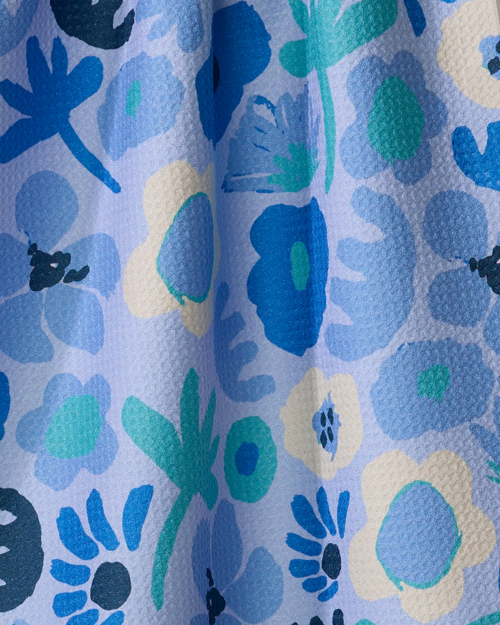 Close-up of Cool Blooms by Sareka Unique: textured fabric made from recycled materials, with a vibrant abstract floral pattern in blue, teal, green, and cream on light blue—a lively design perfect for a quick-drying tea towel.