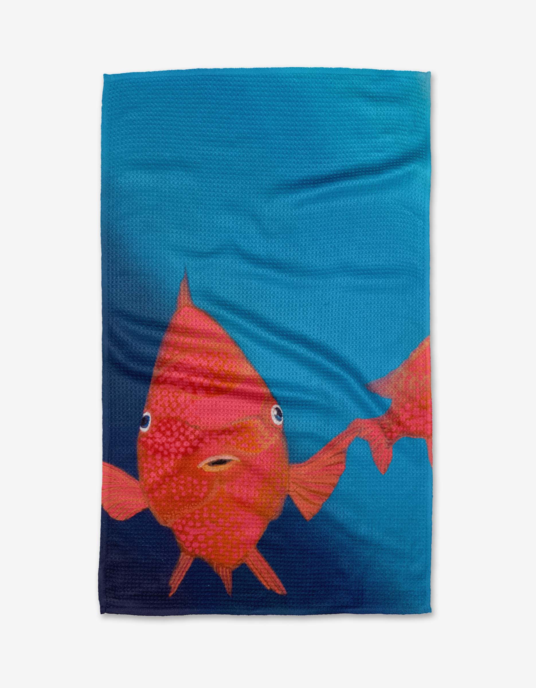 Coral Glow by Trey Jolley: a blue tea towel made from recycled materials, featuring a large orange-red fish with wide eyes, small mouth, and part of another fish on the right edge.