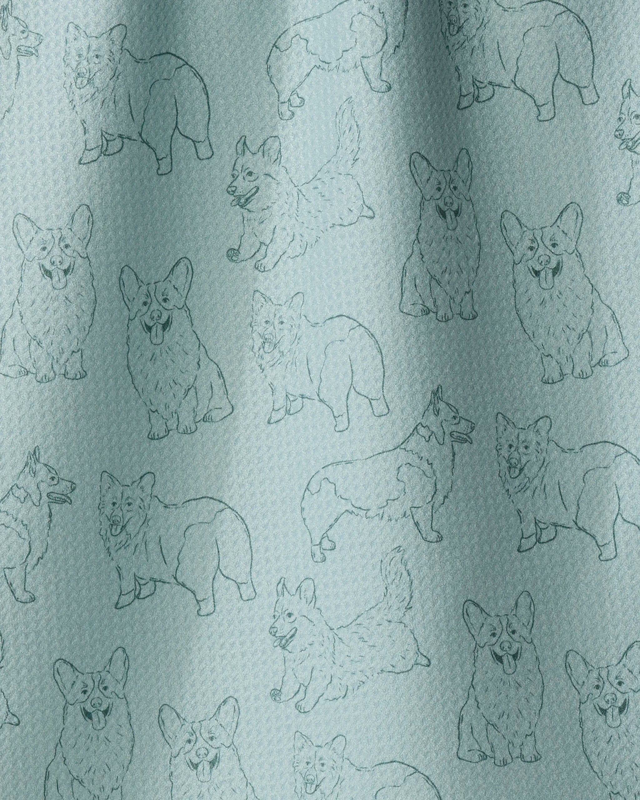 Geometry’s “Corgi Pups” towel features a light blue fabric adorned with a repeating pattern of outlined cartoon corgi dogs in different poses—standing, sitting, and walking. The textured quilted material not only adds visual charm but also ensures the towel is quick-drying and practical for everyday use.