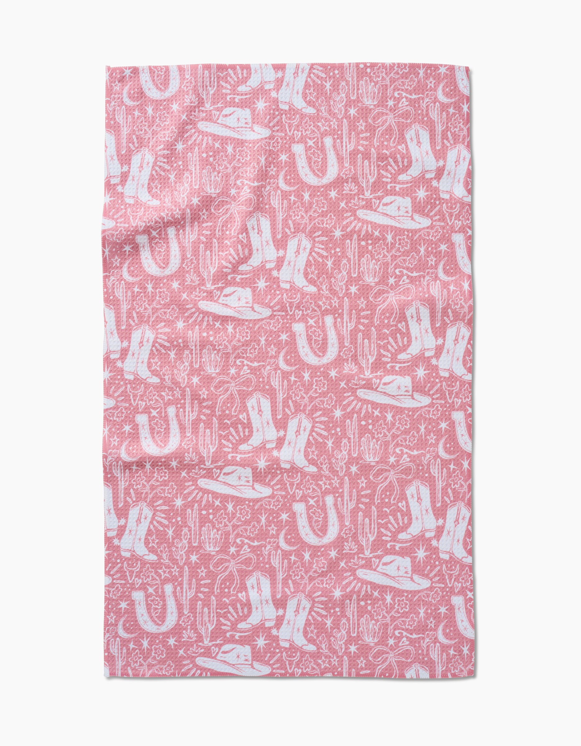 Cowgirl Chic is a pink rectangular cloth made from ultra-absorbent Geoweave fabric, showcasing a white Western-themed pattern with cowboy hats, boots, horseshoes, cacti, lassos, stars, and sheriff badges.