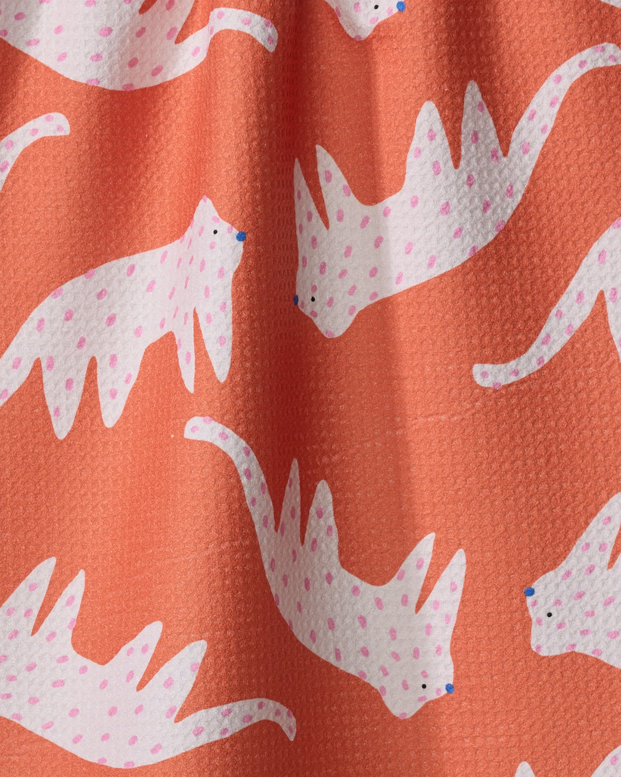 Playful cheetahs adorn the vibrant orange, textured "Cute Cheetah" towel by Jennifer Bouron, made from recycled materials and ultra-absorbent for everyday use.