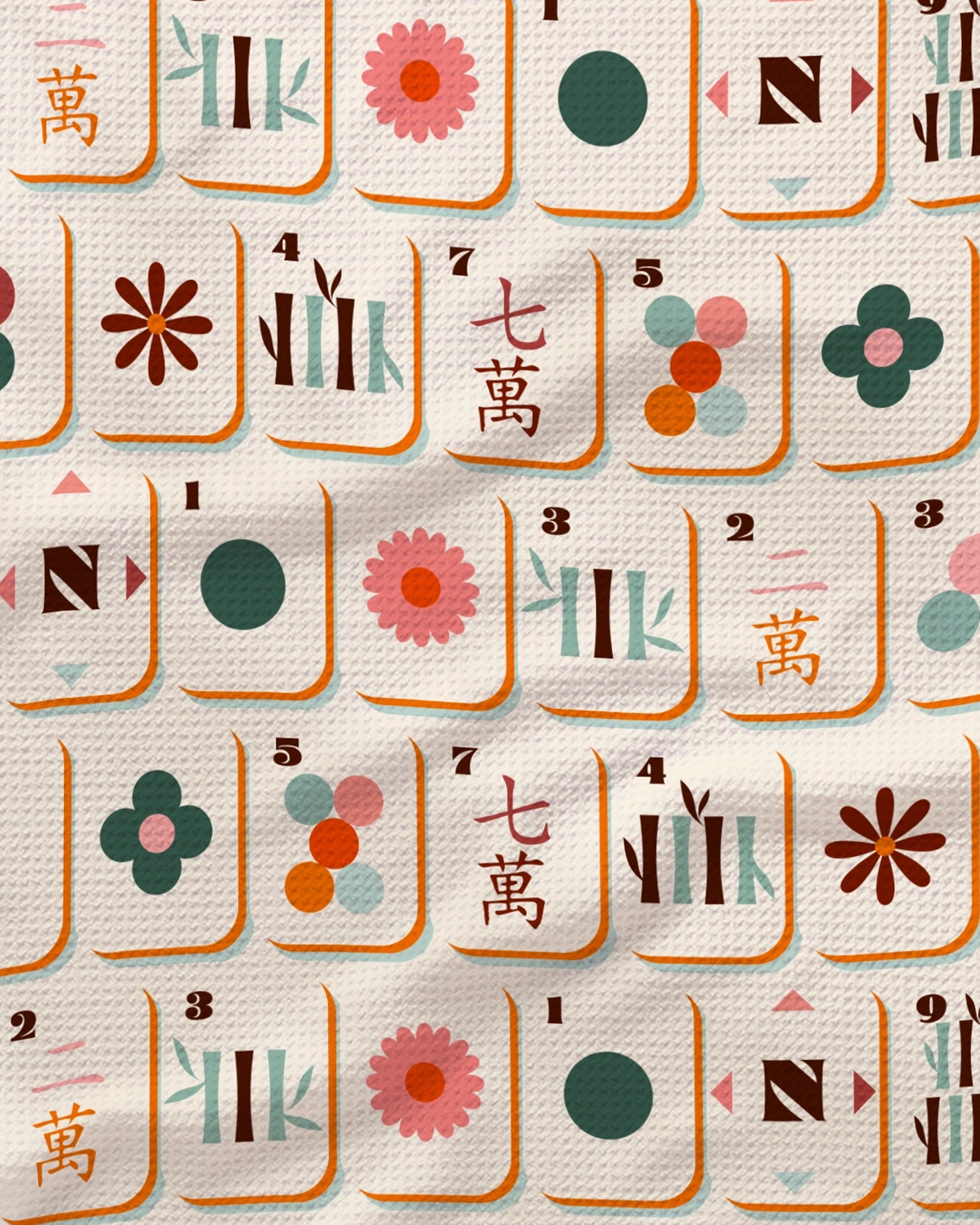 Cypress Tile Toss" by Geometry features Mahjong tiles with dots, bamboos, flowers, and Chinese characters in pastel hues and orange borders, arranged in rows across a textured tea towel. Some tiles appear slightly elevated where the recycled-material kitchen towel gently folds.
