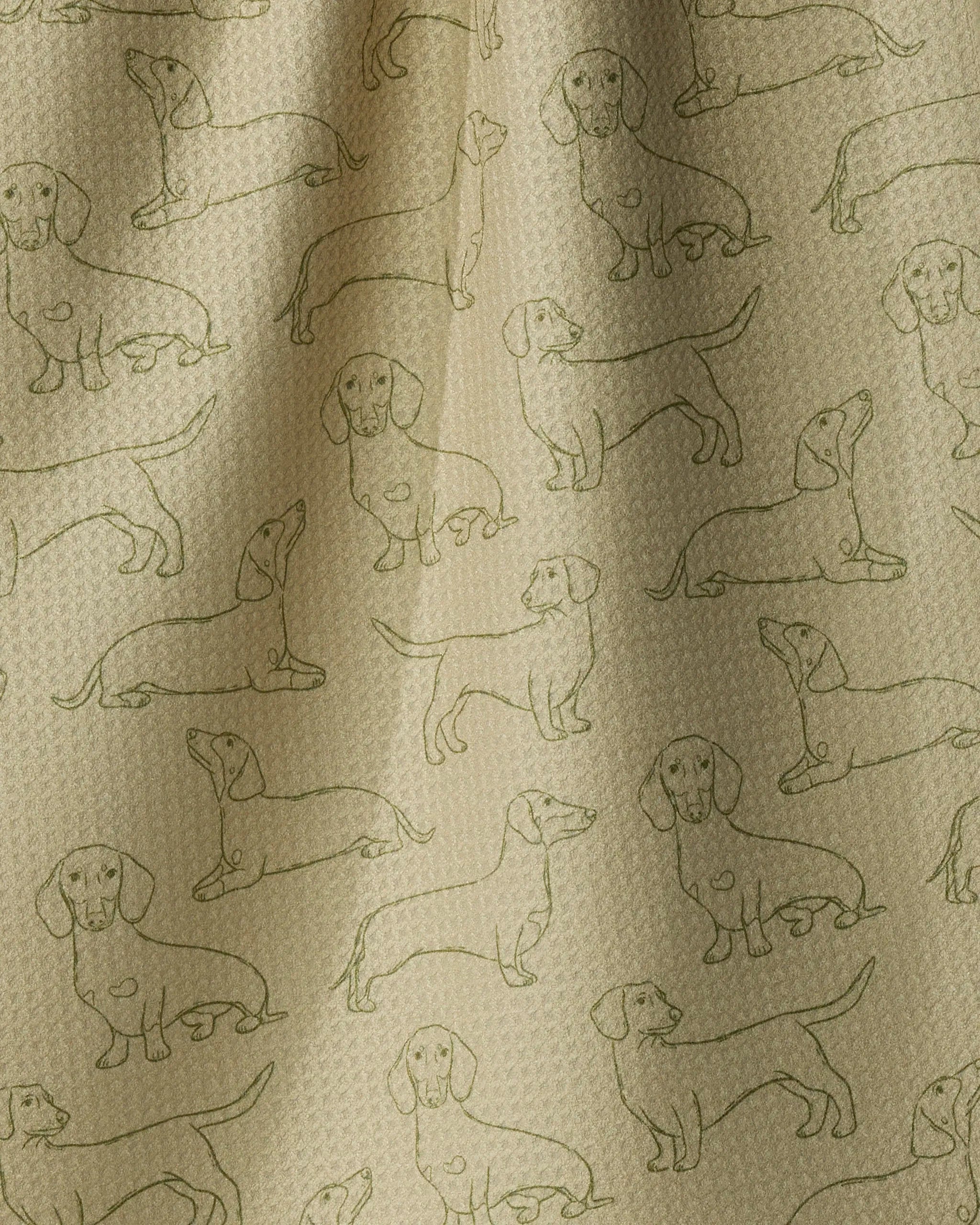 Introducing “Dachshund Pups” by Geometry—a beige kitchen towel crafted from recycled materials, featuring a textured surface with subtle folds. The fabric tea towel showcases a charming repeating pattern of outlined dachshund dogs in various poses, all drawn in green lines.