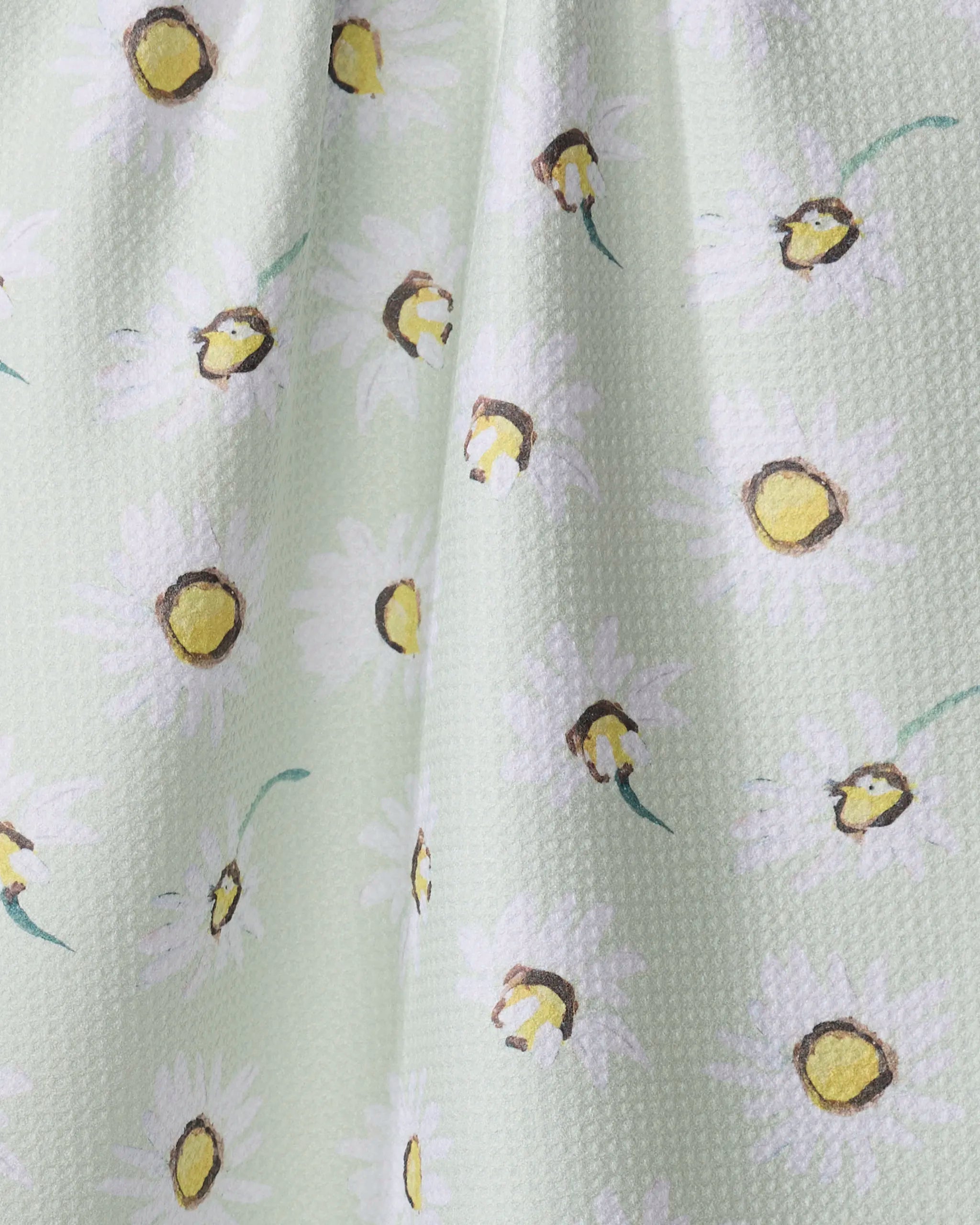 The Daisy Field dish towel by Ania Zwara Art features absorbent textured fabric with hand-painted white daisies and green stems on a pastel background—perfect for brightening your kitchen.