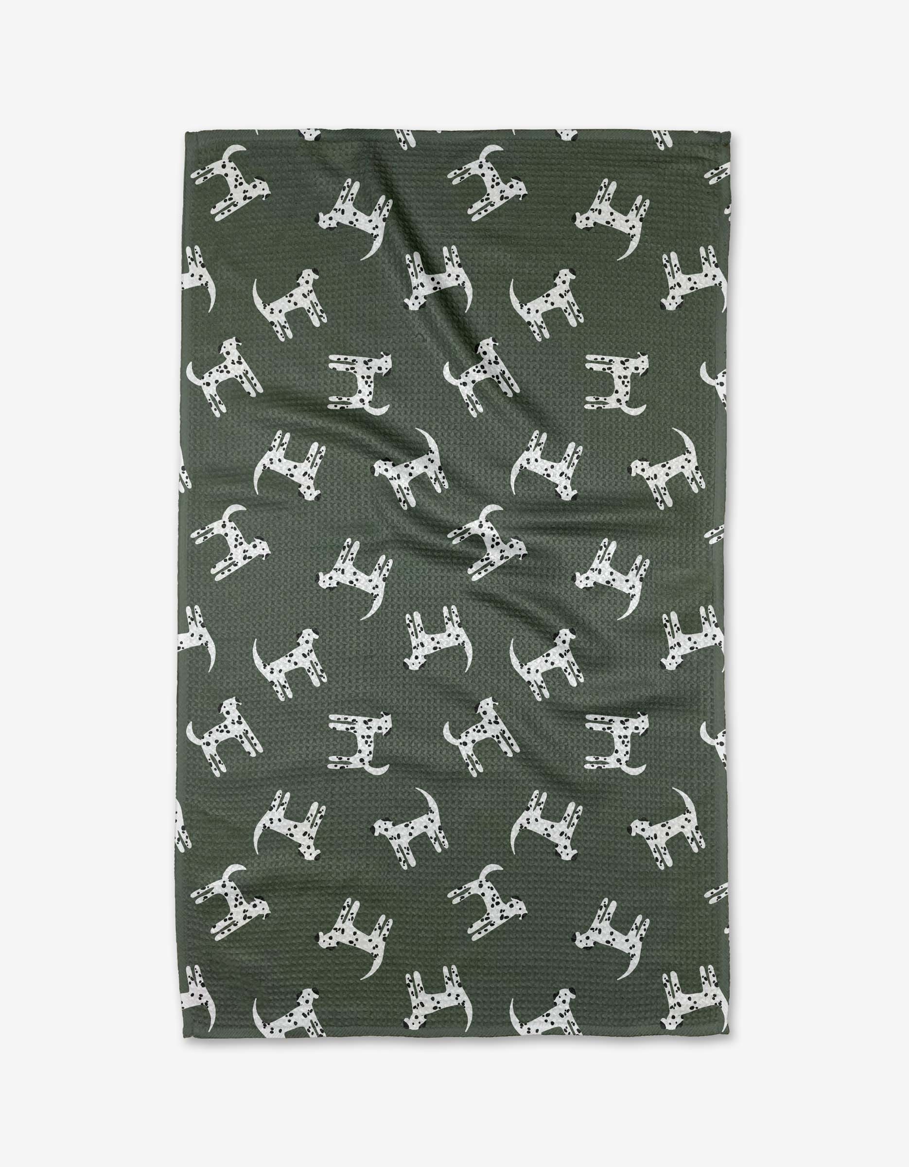 Dalmation Dogs by Coit Creative is a dark green Geoweave fabric with a playful white Dalmatian dog pattern. Made from recycled materials, the fabric is shown laid flat with slight wrinkles.
