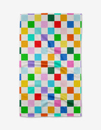 The Dance Floor tea towel by Vaishali Design Studio is a rectangular, eco-friendly kitchen towel with a vibrant checkered pattern in red, blue, green, yellow, orange, and pink on white. Stylish and absorbent for any kitchen.