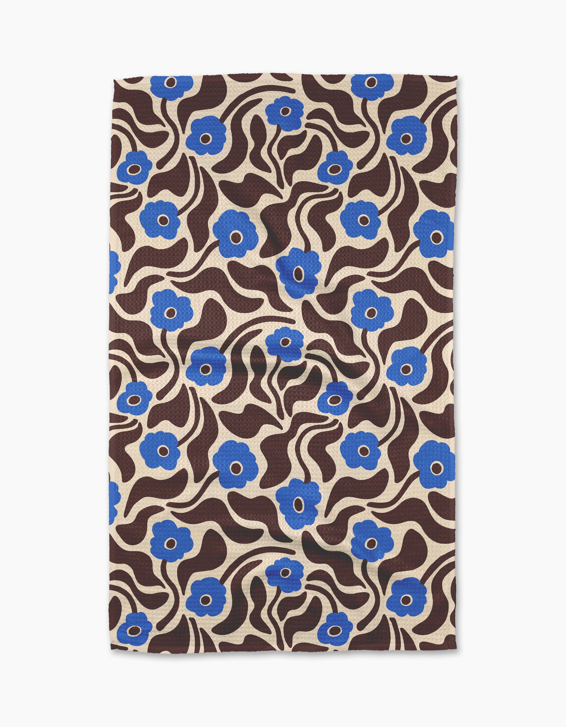 The Gerdadzy Dancing Blooms tea towel features a beige background with blue flowers, wavy brown lines, and leaves in a bold, retro style. Made from recycled materials.