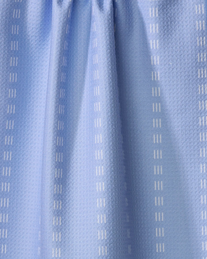 The Buy Guide's Dashing - French Blue kitchen towel is crafted from recycled materials, featuring a subtle textured pattern with vertical white dashed lines and soft pleats at the top.