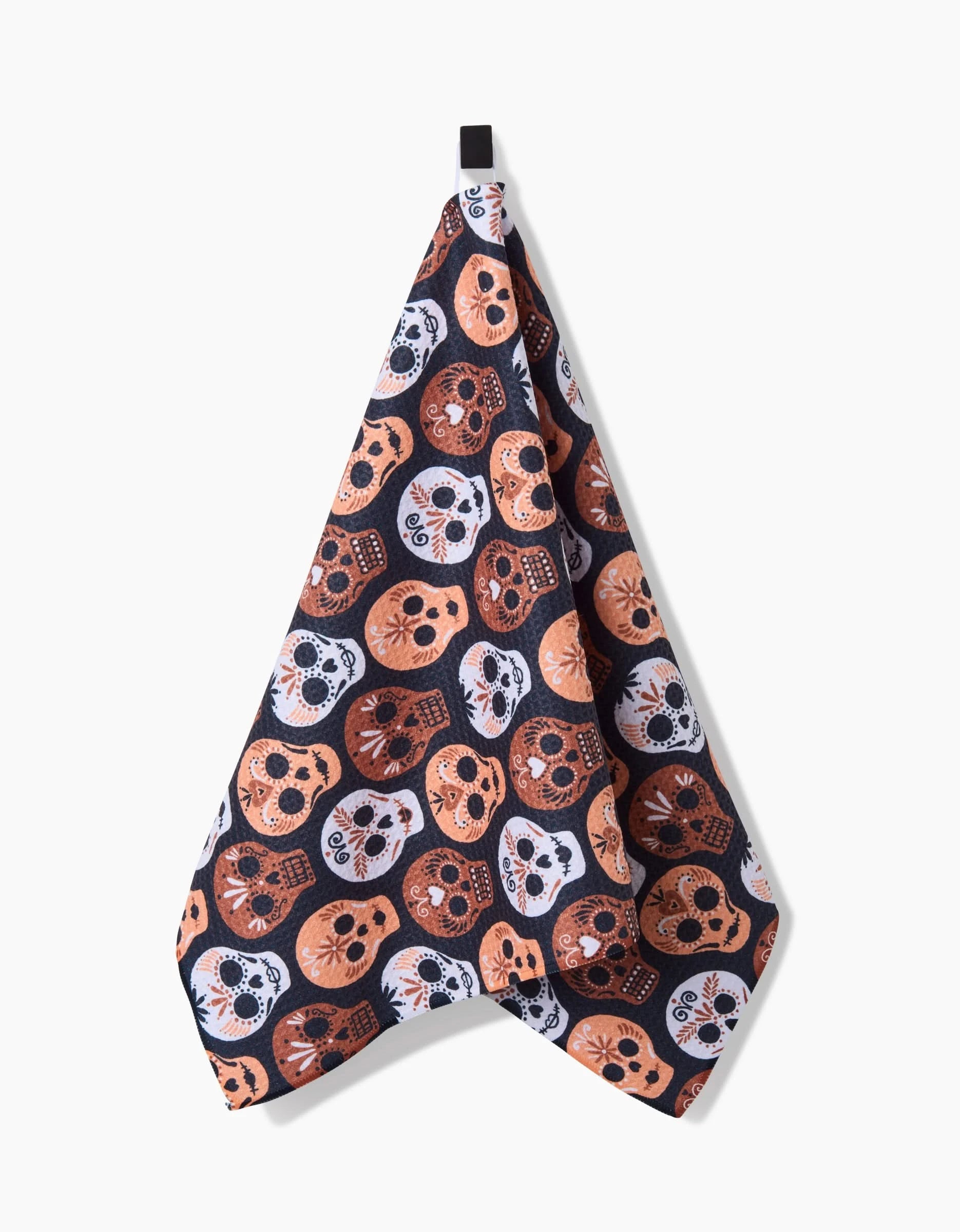 The Hufton Studio Day Of The Dead Skulls kitchen tea towel is quick-drying and hangs easily, featuring a vibrant sugar skull pattern in orange, black, and white.