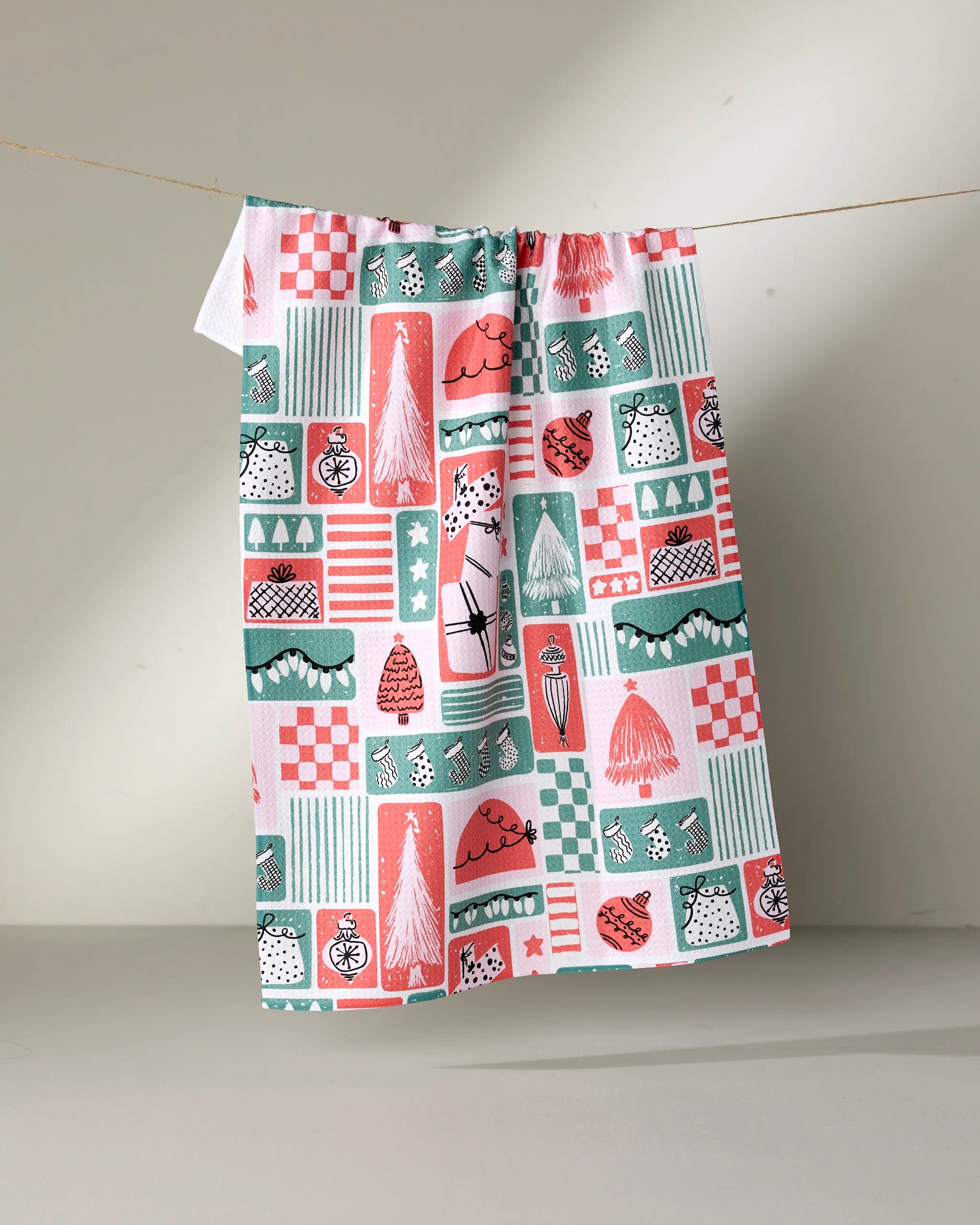 The Days of Christmas towel by Charlie Rowan Designs hangs on a rope—ultra-absorbent and perfect for everyday kitchen use or as a stylish tea towel.