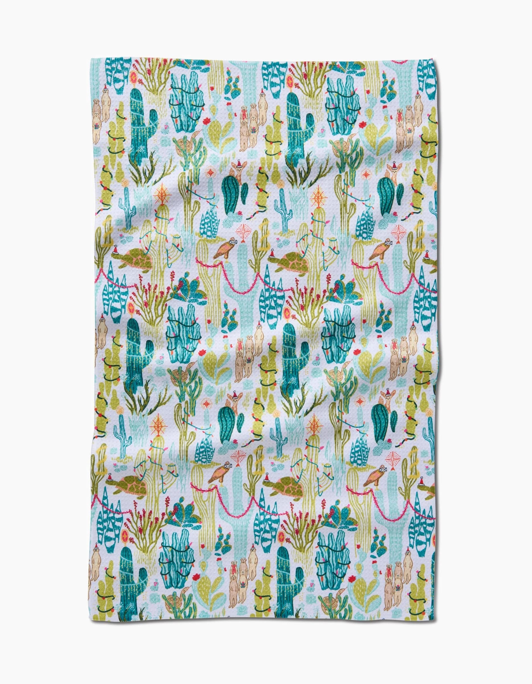 Desert On Holiday by Elisabeth Wing is a colorful kitchen towel with cacti, succulents, and desert plants in green, blue, and pink on white. Made from eco-friendly fabric with a touch of natural wrinkle for added charm.