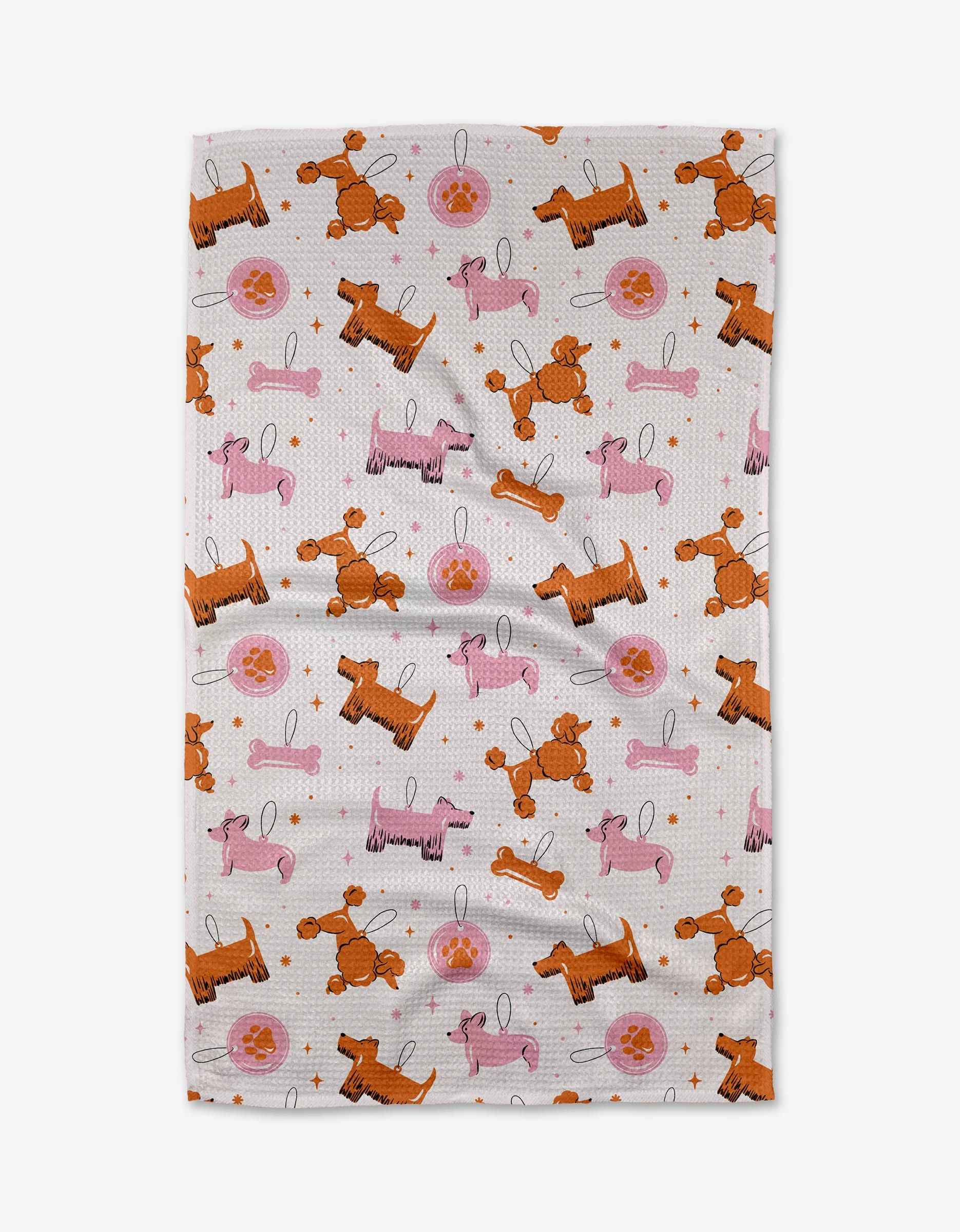 The Megan Roy Dog Ornaments tea towel features a playful pattern of orange and pink cartoon poodles, pink tennis balls, leashes, and stars on an ultra-absorbent white surface.