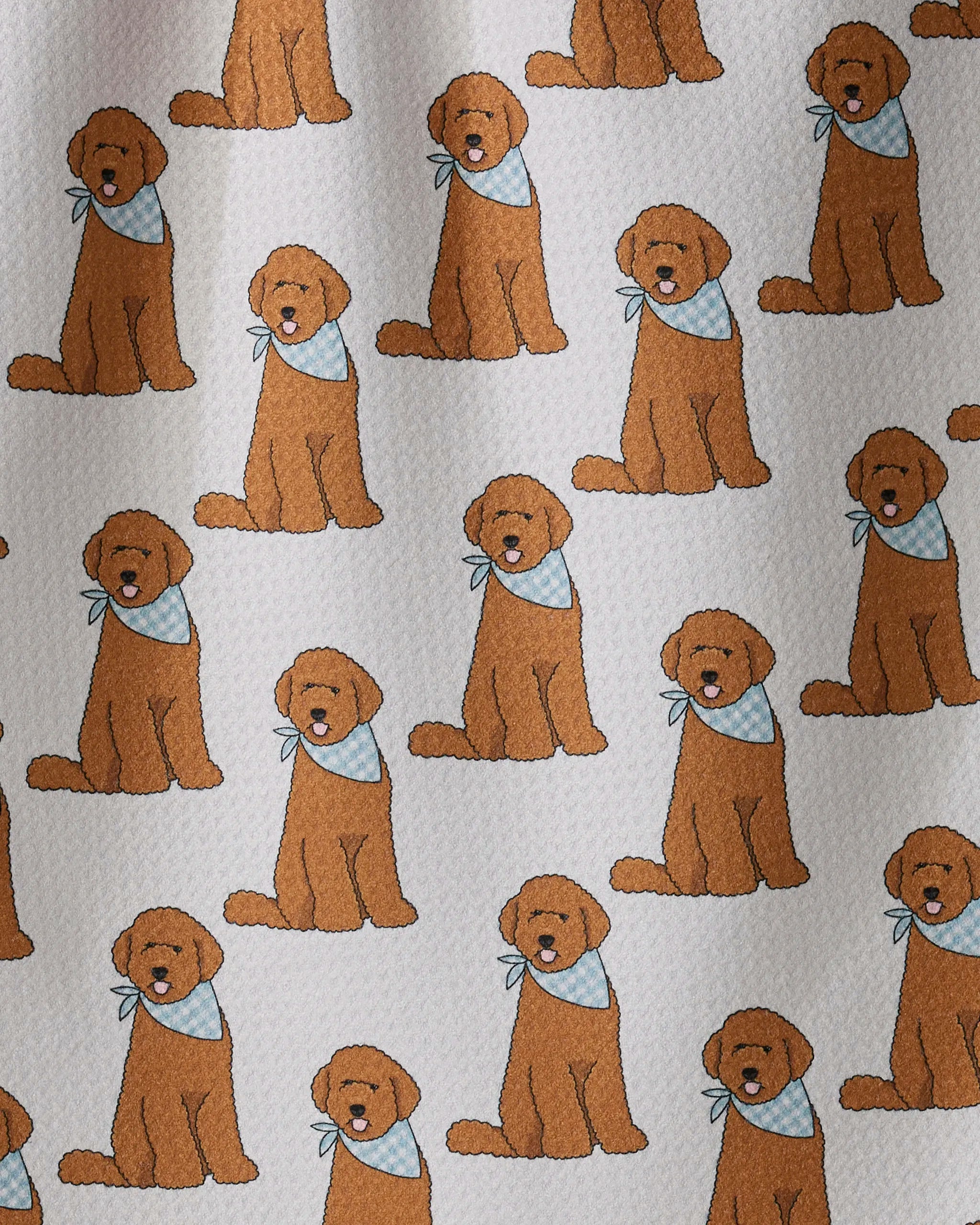 A playful pattern called “Doodle Days” by Geometry features cartoon brown dogs sporting blue and white bandanas, sitting on a light textured background—perfect for a quick-drying towel or kitchen tea towel made from recycled materials.