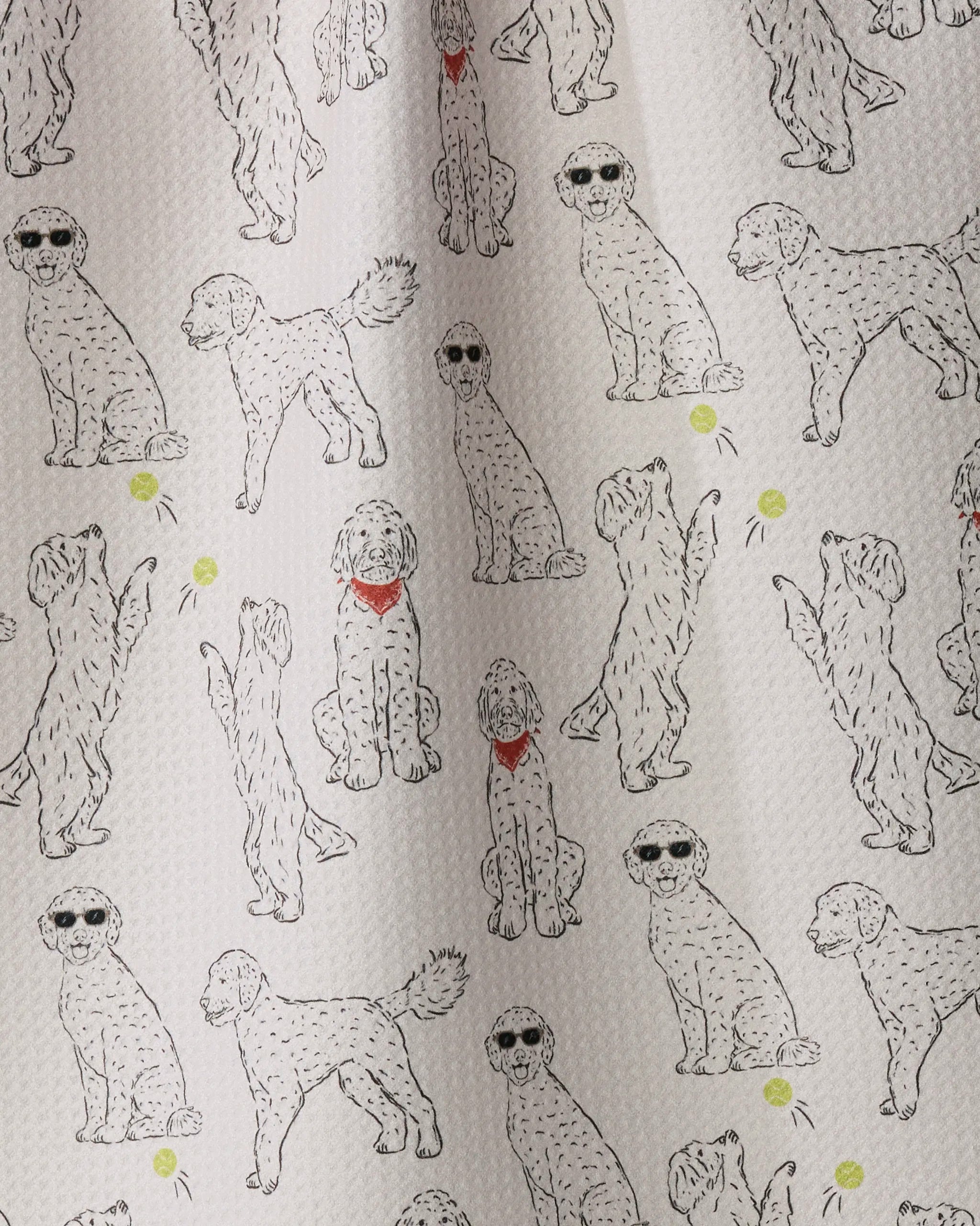 Add playful charm to your kitchen with Geometry’s Doodle Daze tea towel, featuring a pattern of doodle dog illustrations on a textured white background. Some pups sport sunglasses, others wear red bandanas, and a few are busy playing with yellow balls—all captured in delightful, lively poses. Made from recycled materials, Doodle Daze is both eco-friendly and stylishly cheerful.