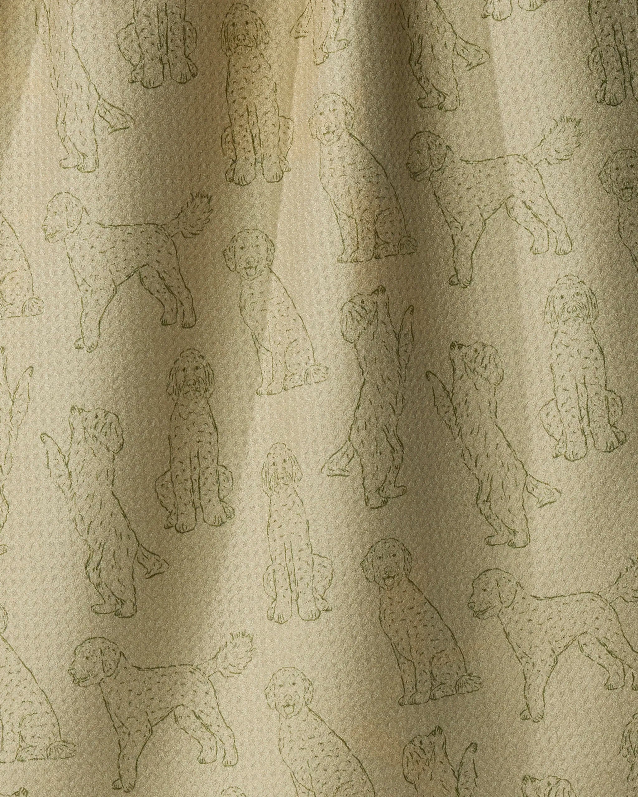 Geometry’s Doodle Pups towel features a beige fabric with a repeating pattern of outlined, doodle-style dogs in various playful poses such as sitting, standing, and reaching up. The quick-drying towel offers a subtly textured surface, and soft lighting casts gentle shadows to highlight its cheerful design.