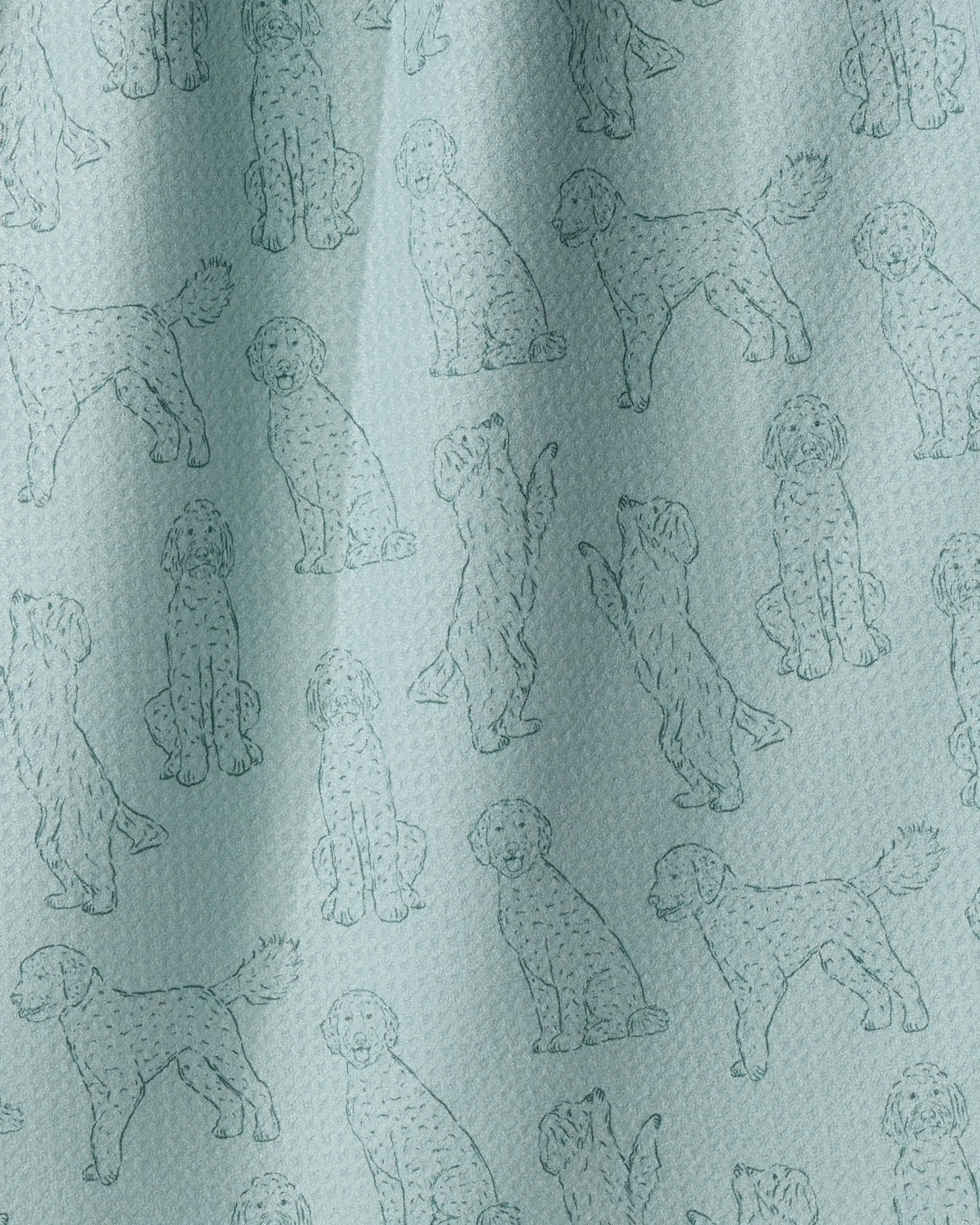 Introducing “Doodle Pups” by Geometry—a light blue recycled kitchen towel featuring a whimsical, repeated line-drawing pattern of dogs in playful poses like sitting, standing, and jumping. Eco-friendly and practical, this charming towel brings a fun touch to your kitchen décor.