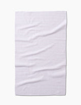 The Geometry Dot Dot Dot Blushed Bergamot is a white tea towel made from recycled materials, featuring a subtle light pink geometric pattern, shown flat and slightly wrinkled against a white background.
