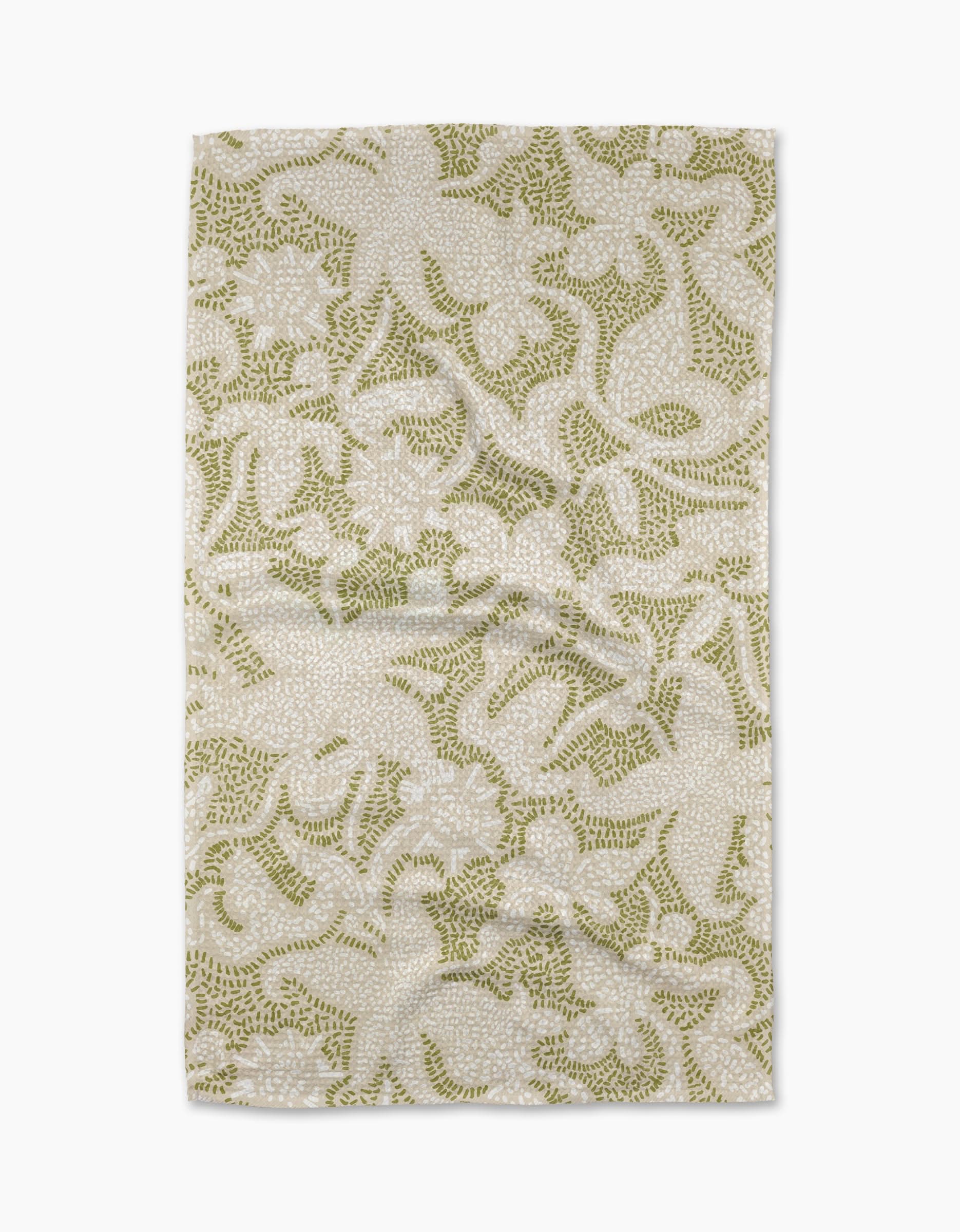 The Dotted Floral Garden Tea Towel by Geometry features an intricate green botanical pattern on a beige background and is crafted from recycled materials for sustainability.