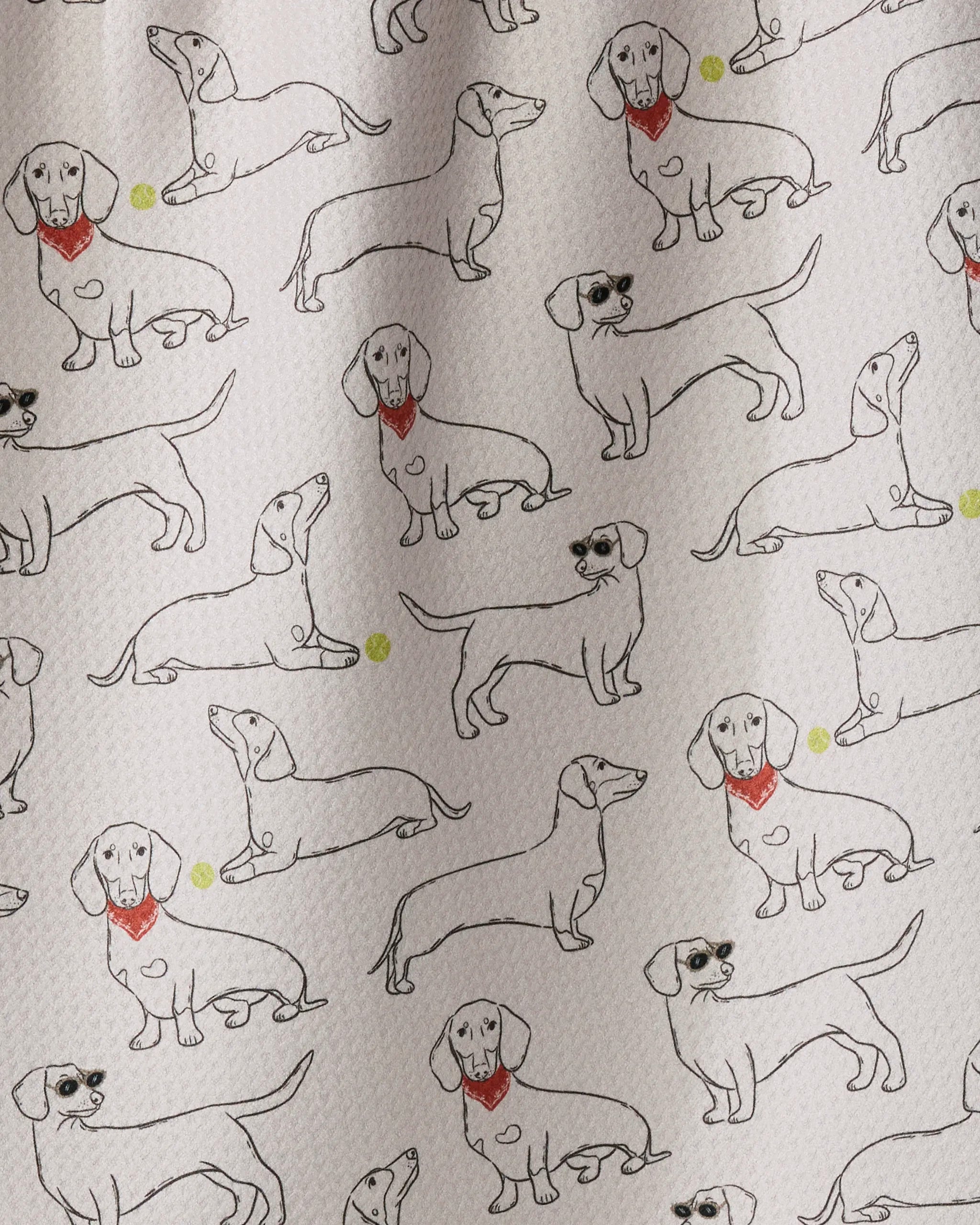 Featuring Geometry’s Doxie Pals, this eco-friendly kitchen towel showcases an array of outlined dachshund dogs in various poses—some sporting red bandanas or sunglasses—with playful yellow balls scattered across a textured white background, making it the perfect addition to your tea towel collection.