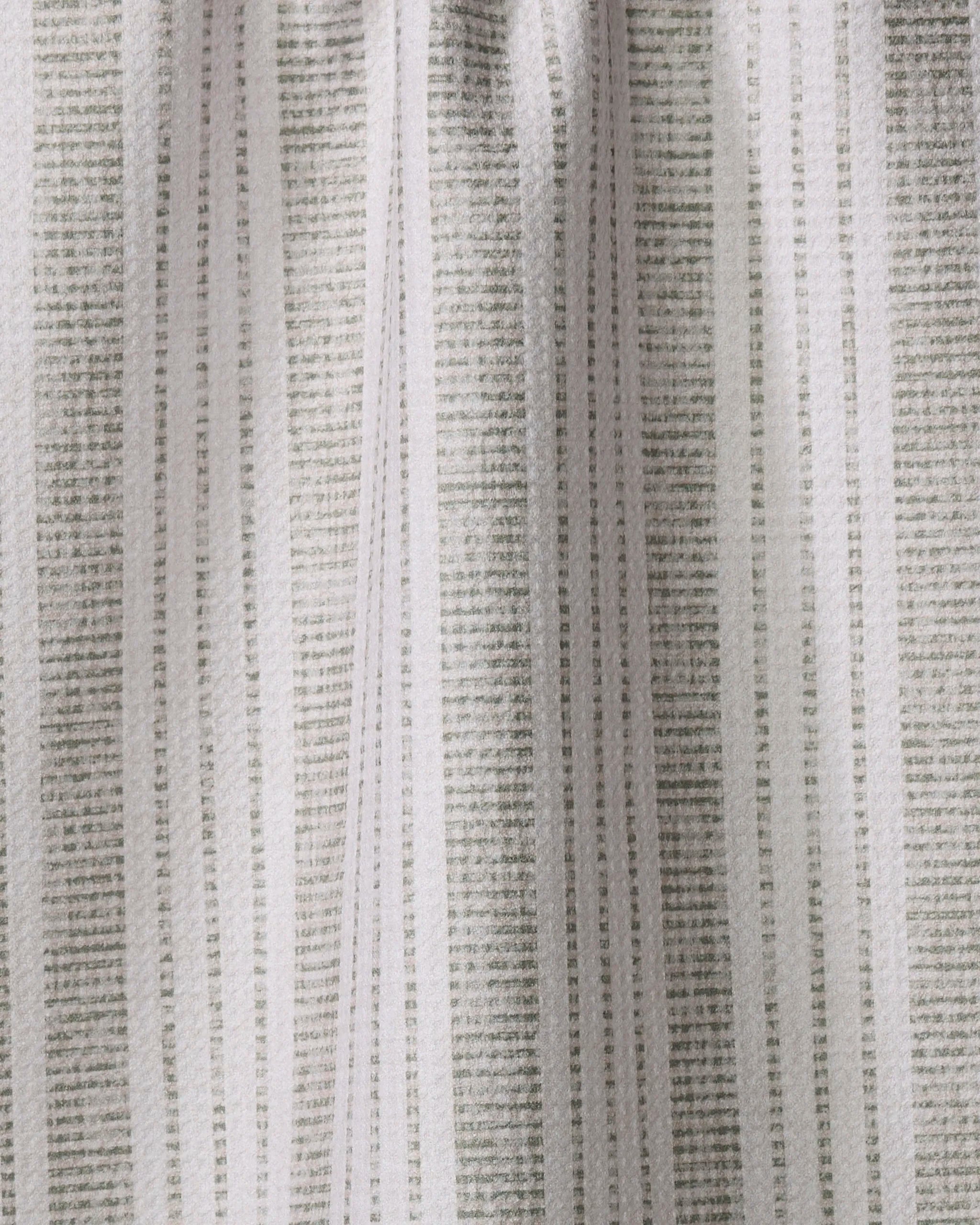 Close-up of the Becki Owens Dyer Sage tea towel, showcasing vertical light and dark gray stripes, an ultra-absorbent, slightly wrinkled texture, and soft lighting.