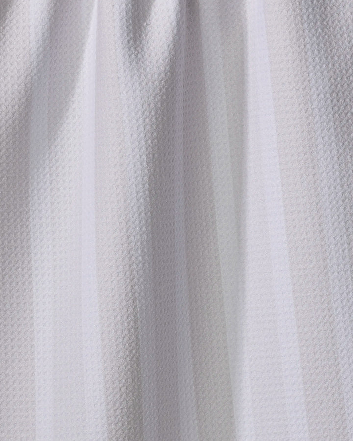 Close-up of Earn Your Stripes - Beige by The Buy Guide, an eco-friendly kitchen towel featuring a light beige color, subtle vertical stripes, and a woven texture. The gently gathered fabric highlights its soft folds and surface details.
