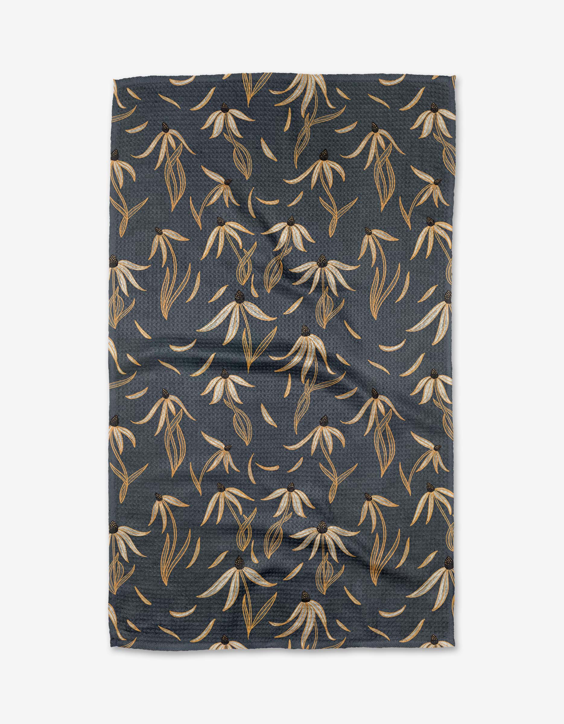 The Echinacea tea towel by Katie OShea features a dark blue Geoweave fabric with cream, tan, and brown botanical leaves and flowers in a diagonal repeating pattern.