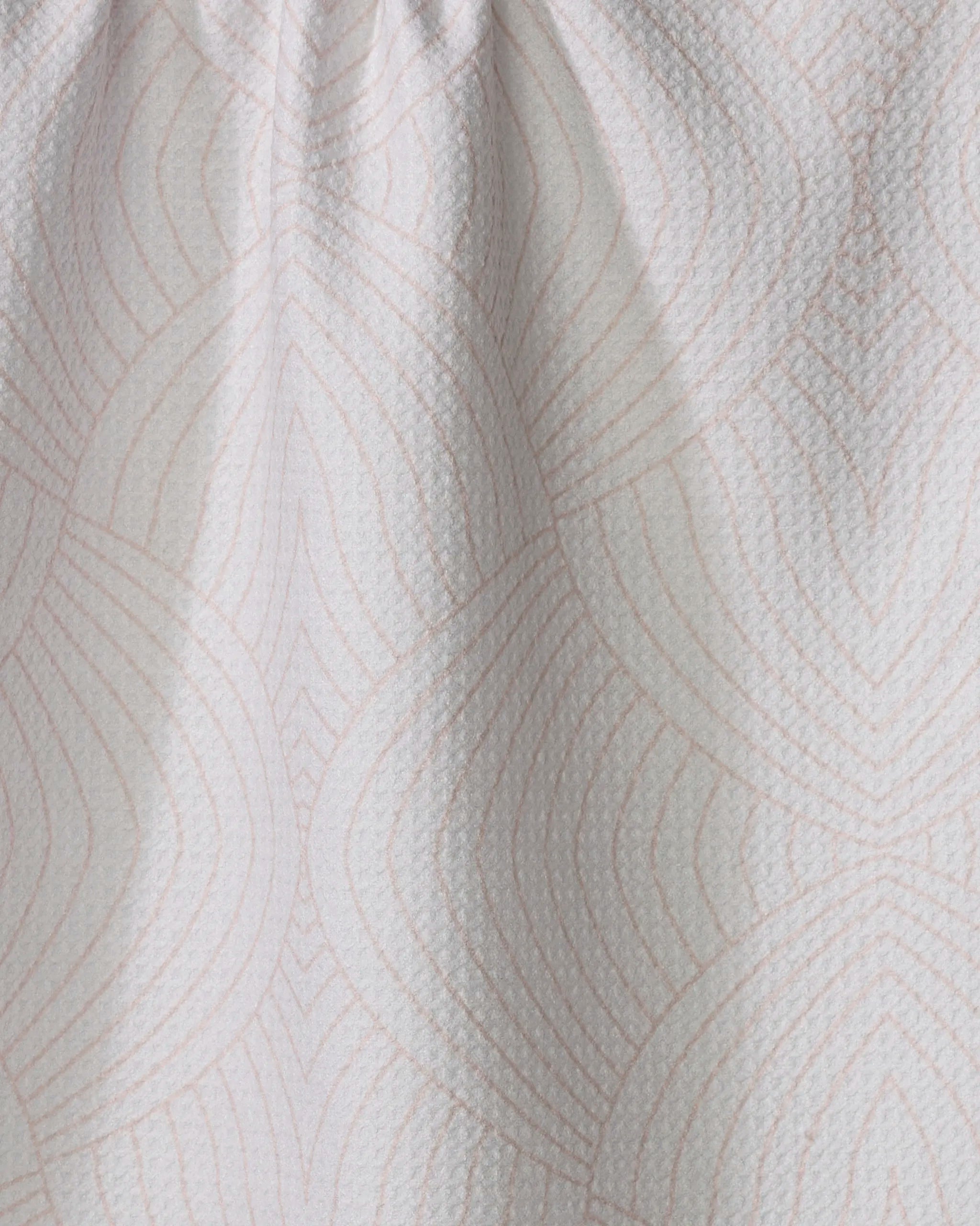 The Eileen tea towel by Amy MacCready is made from recycled materials and features a subtle geometric pattern of overlapping pink lines, with slight gathering at the top for added texture.