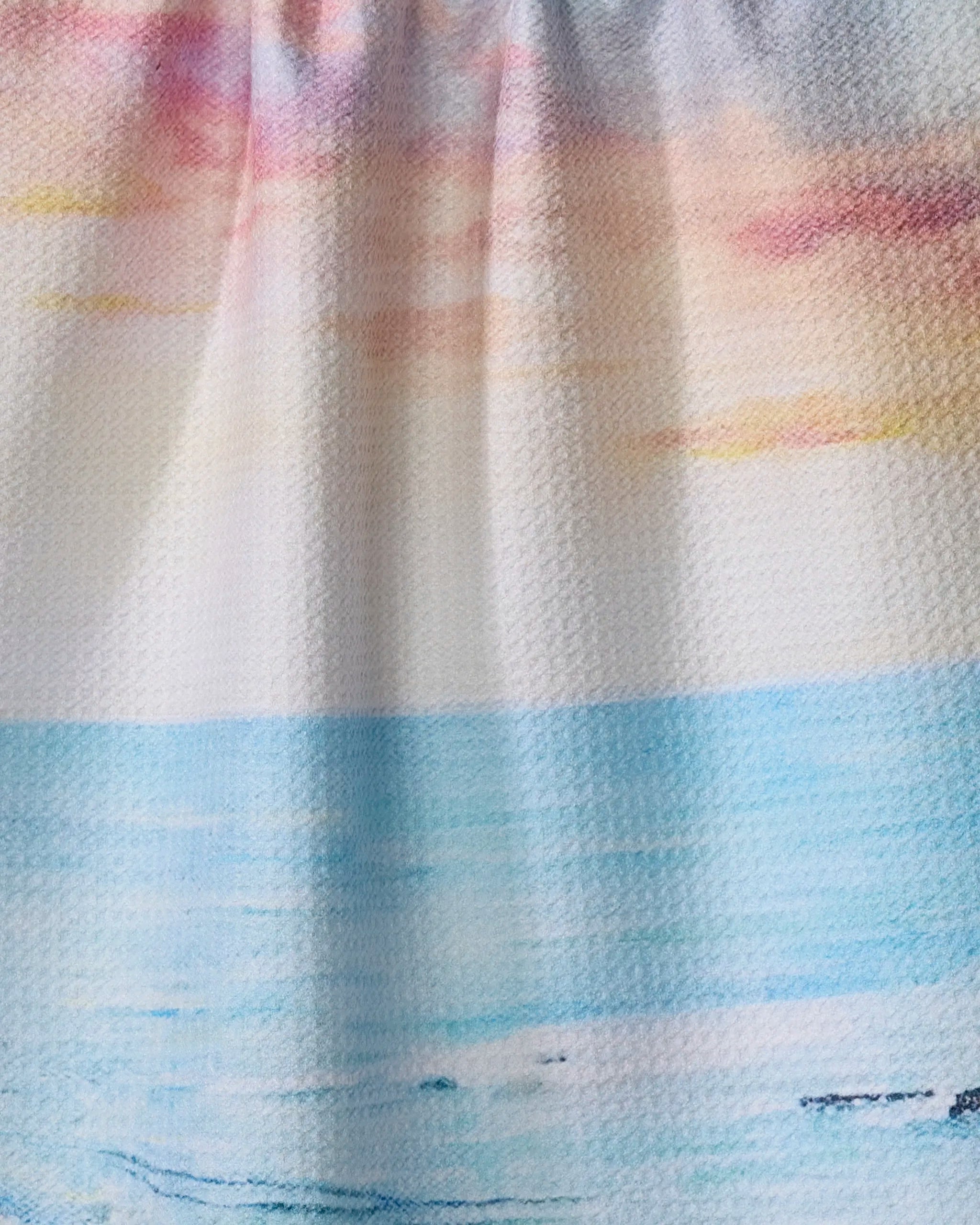 Epiphany" by Stefanie Bales—a pastel seascape with calm blue water, pale sand, and a softly colored sky—beautifully printed on a textured recycled kitchen towel.